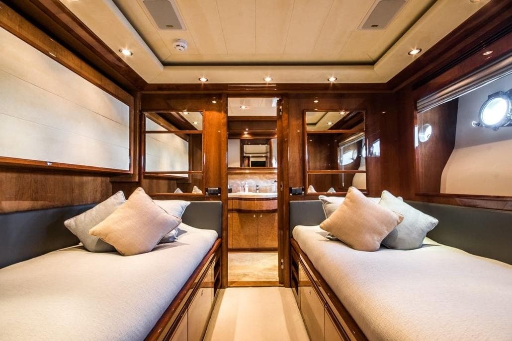 Luxurious interior of 2006 Ferretti Yachts 112 Custom Line with twin beds and elegant wood finish.