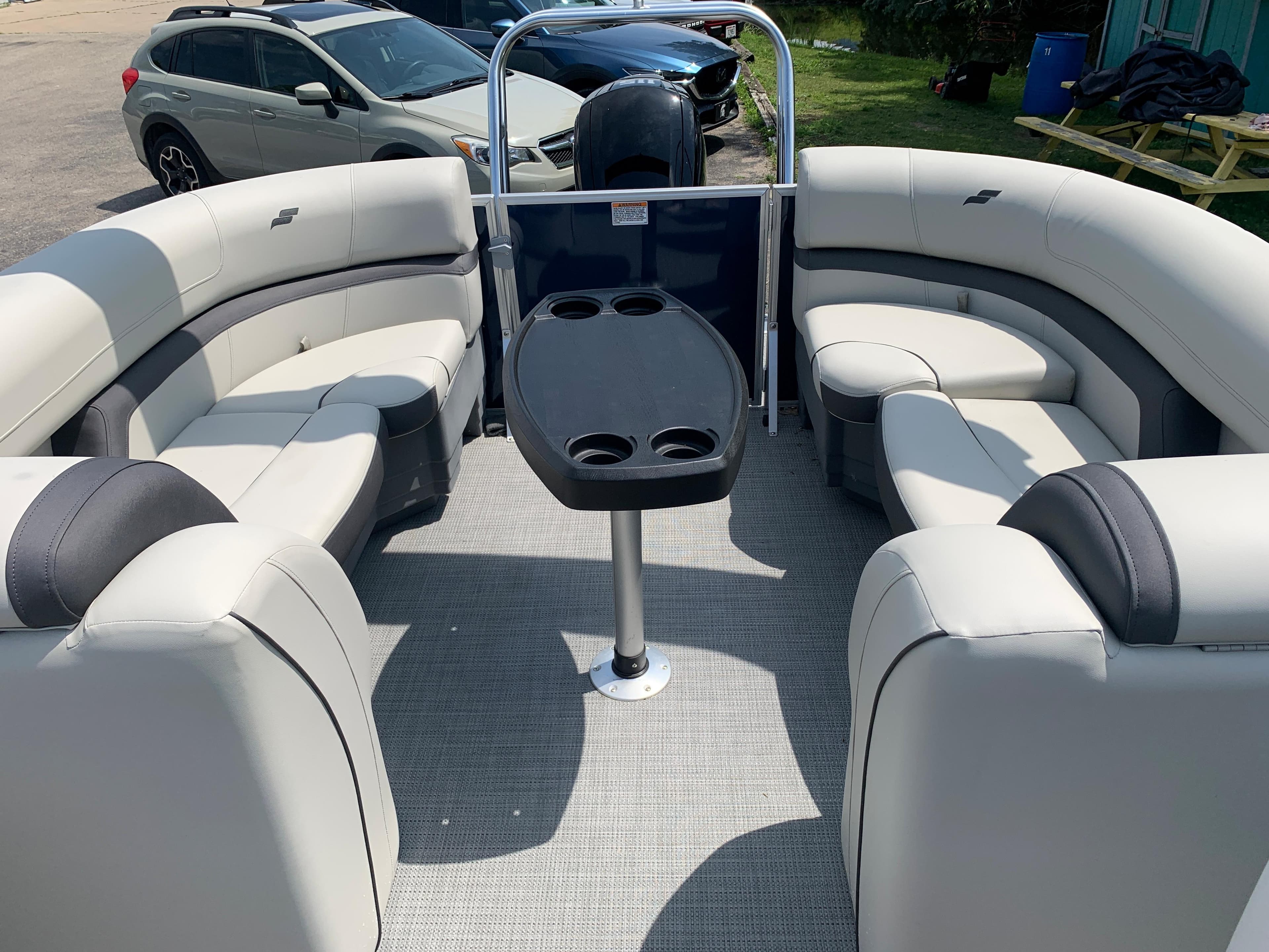 2023 Starcraft EX 24 R pontoon boat interior with spacious seating and table.