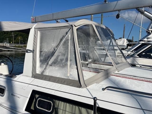 2017 Beneteau Oceanis 38.1 sailboat with cockpit enclosure, docked in marina.