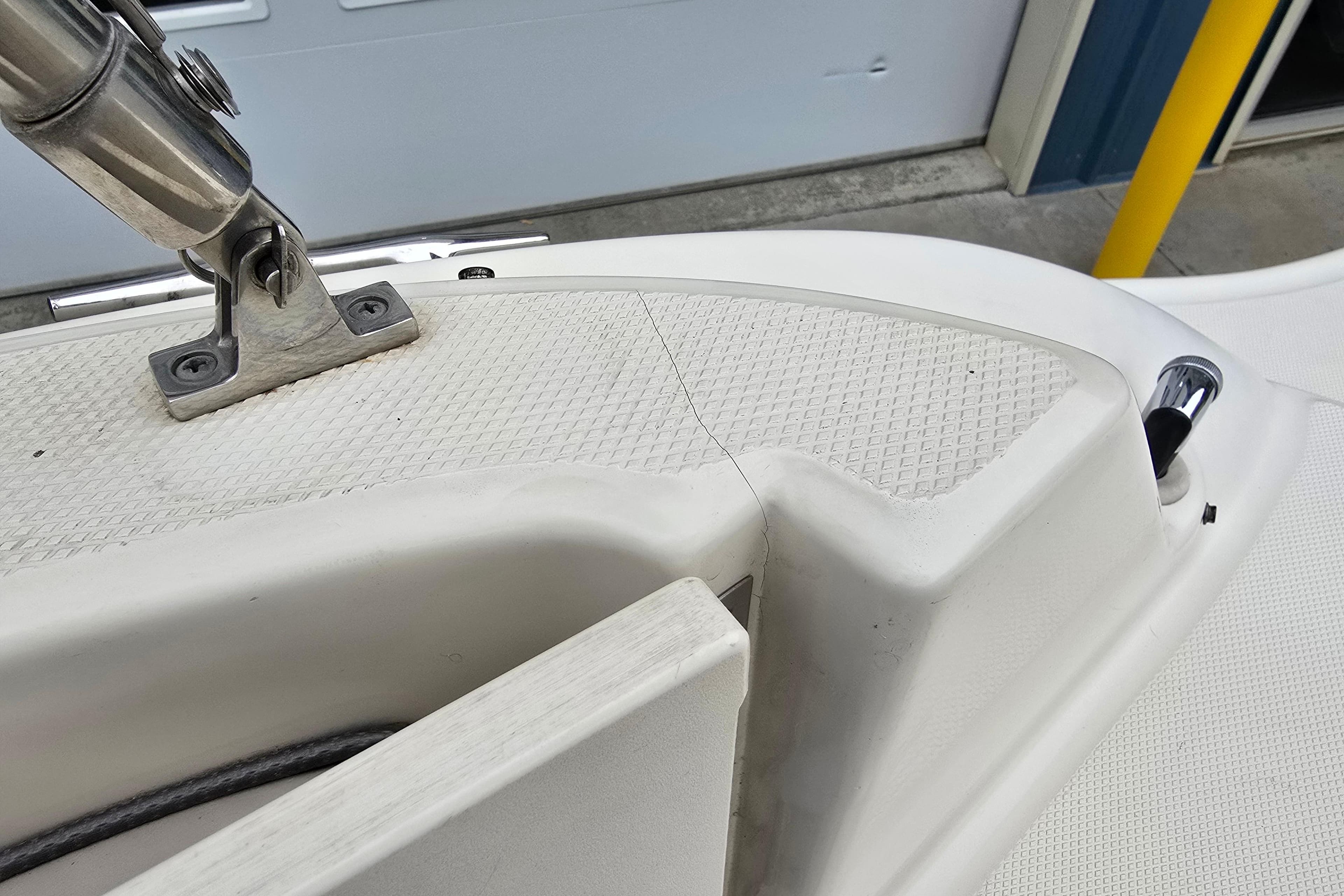 Close-up of 2003 Sea Ray 220 Sundeck boat deck with stainless steel fittings.