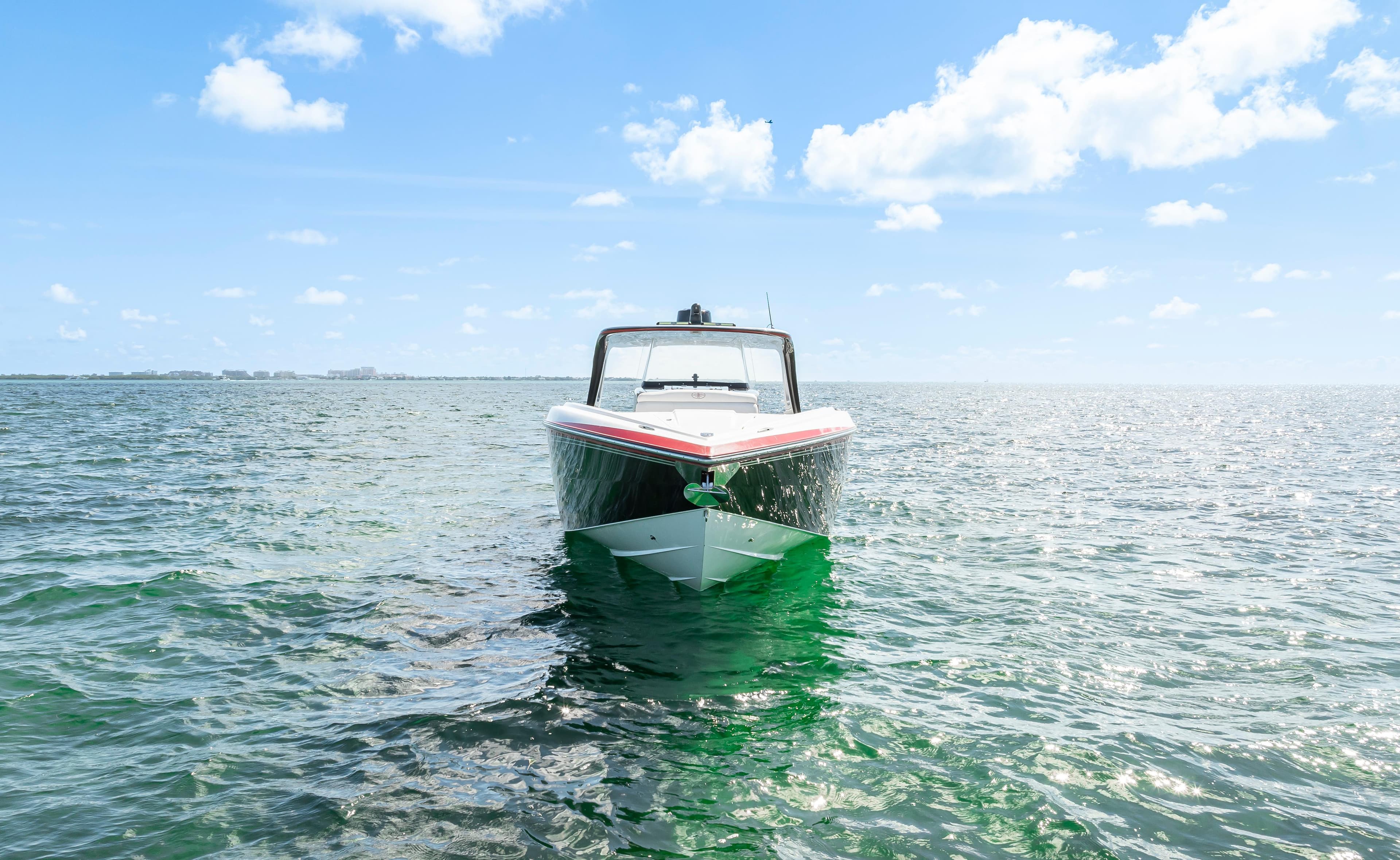 2016 Cigarette 41 GTR boat on open water under a clear blue sky.