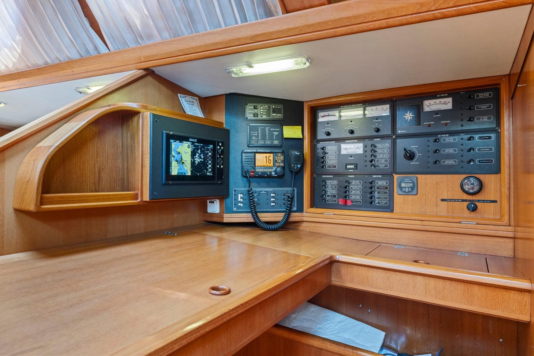 Navigation station of 2001 Jeanneau Sun Odyssey 52.2 yacht with control panels and equipment.