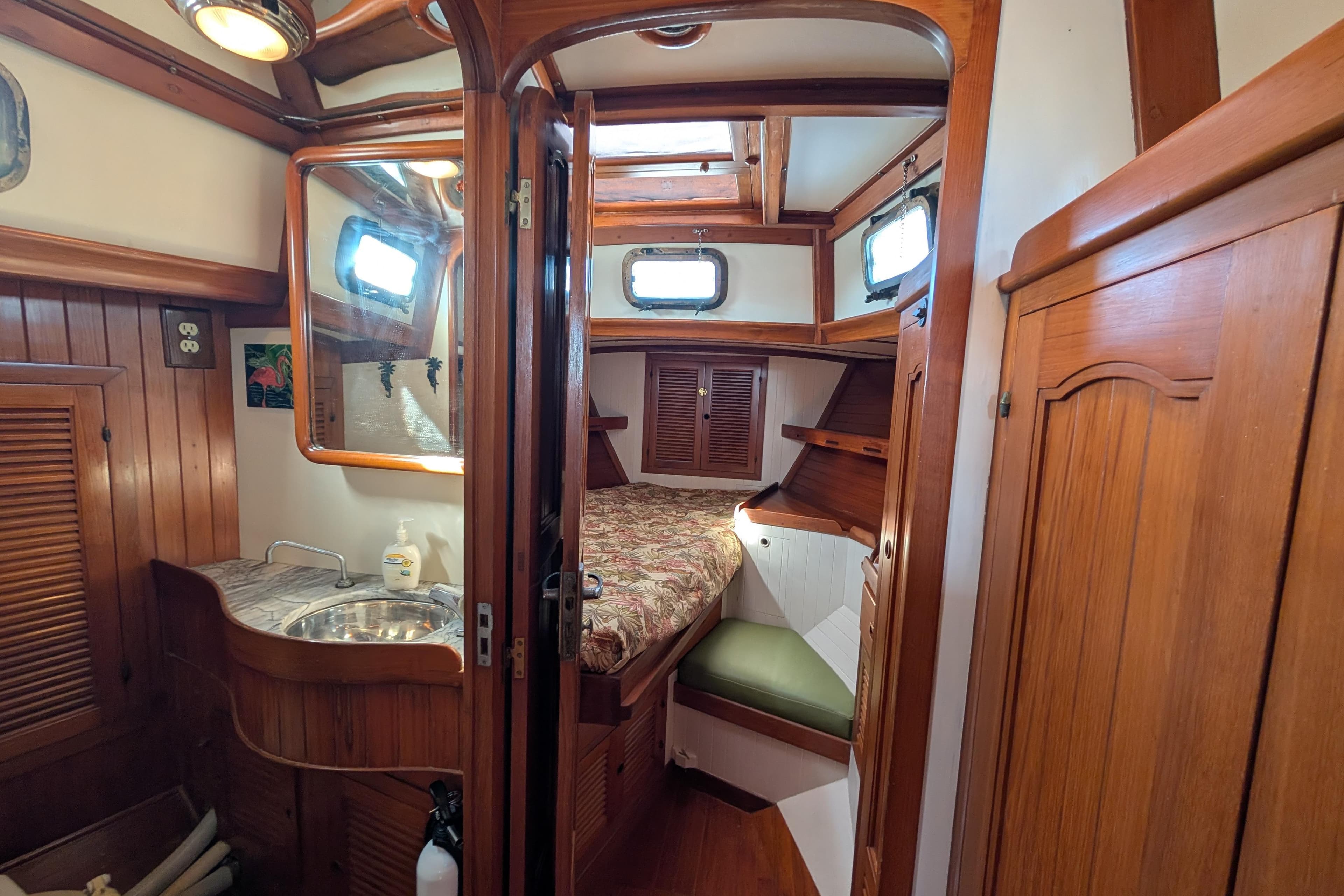 Cozy 1981 Mason 43 yacht cabin with wooden interior and compact amenities.