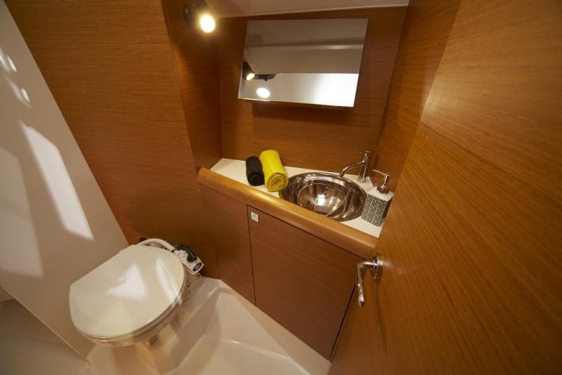 Manufacturer Provided Image: 2019 Jeanneau Sun Odyssey 349 bathroom with sink, mirror, and toilet.