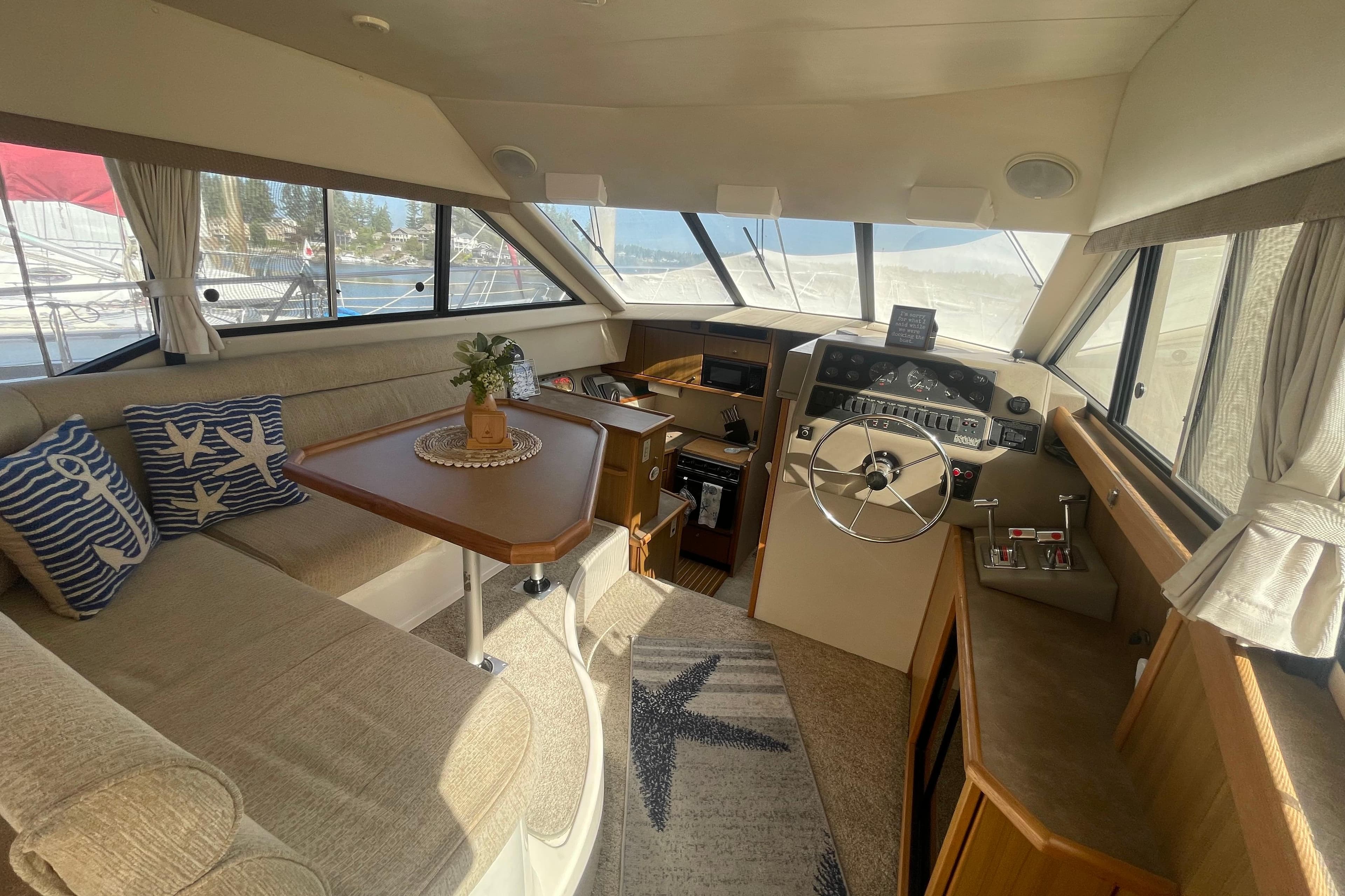 Interior of 2001 Bayliner 3388 Command Bridge Motoryacht with helm, seating, and nautical decor.