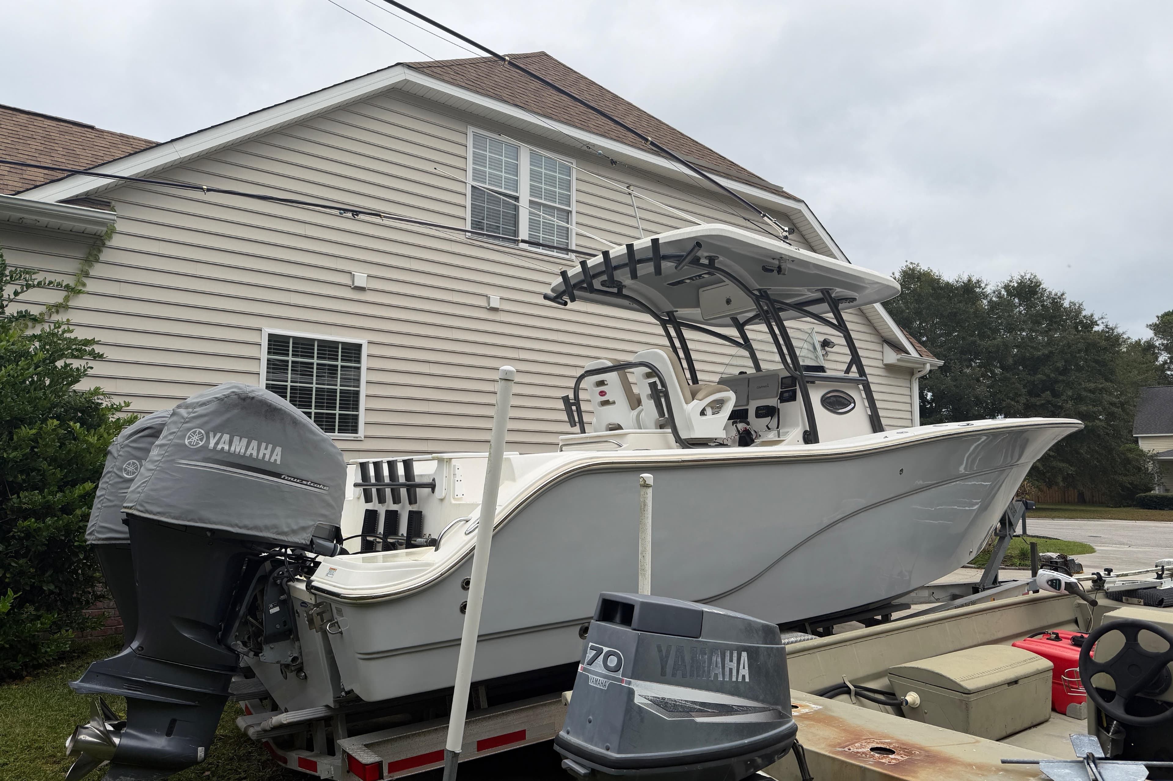 2015 Sea Fox 286 Commander boat with Yamaha engine, parked near a house.