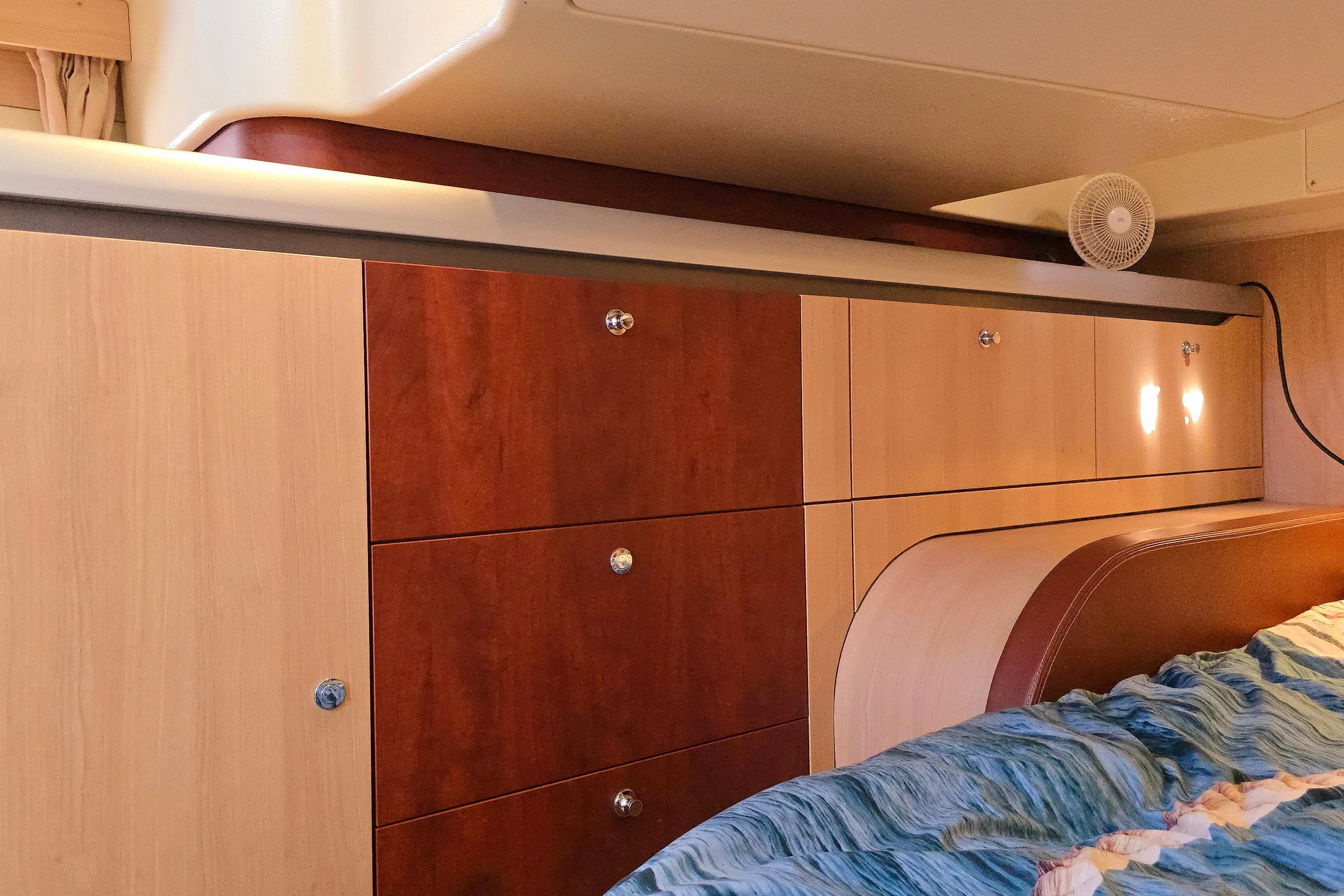 Interior of 2007 Etap 46 DS yacht with wooden cabinetry and bedding.