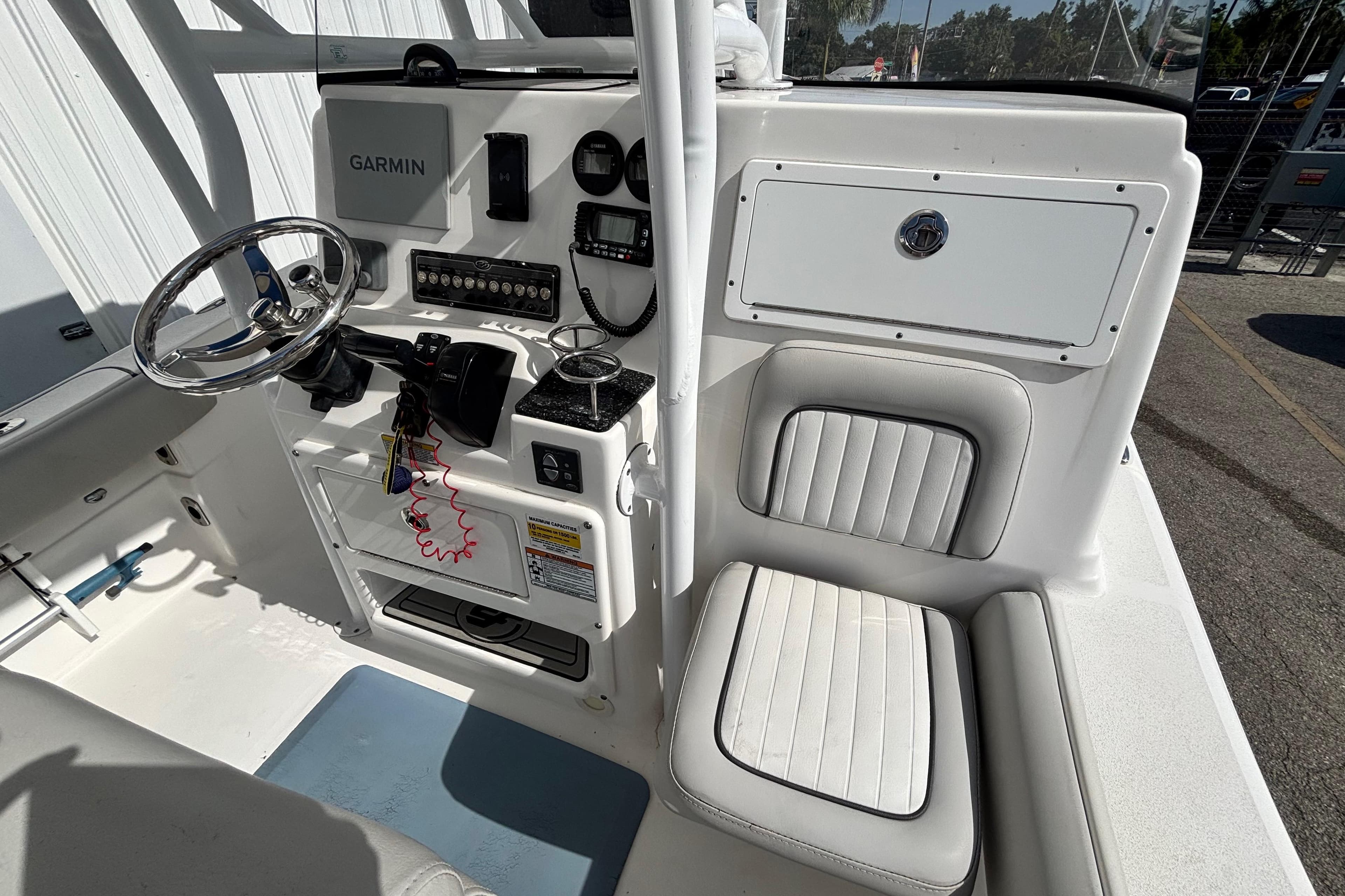 2021 Sea Fox 249 Avenger boat cockpit with Garmin navigation and cushioned seating.