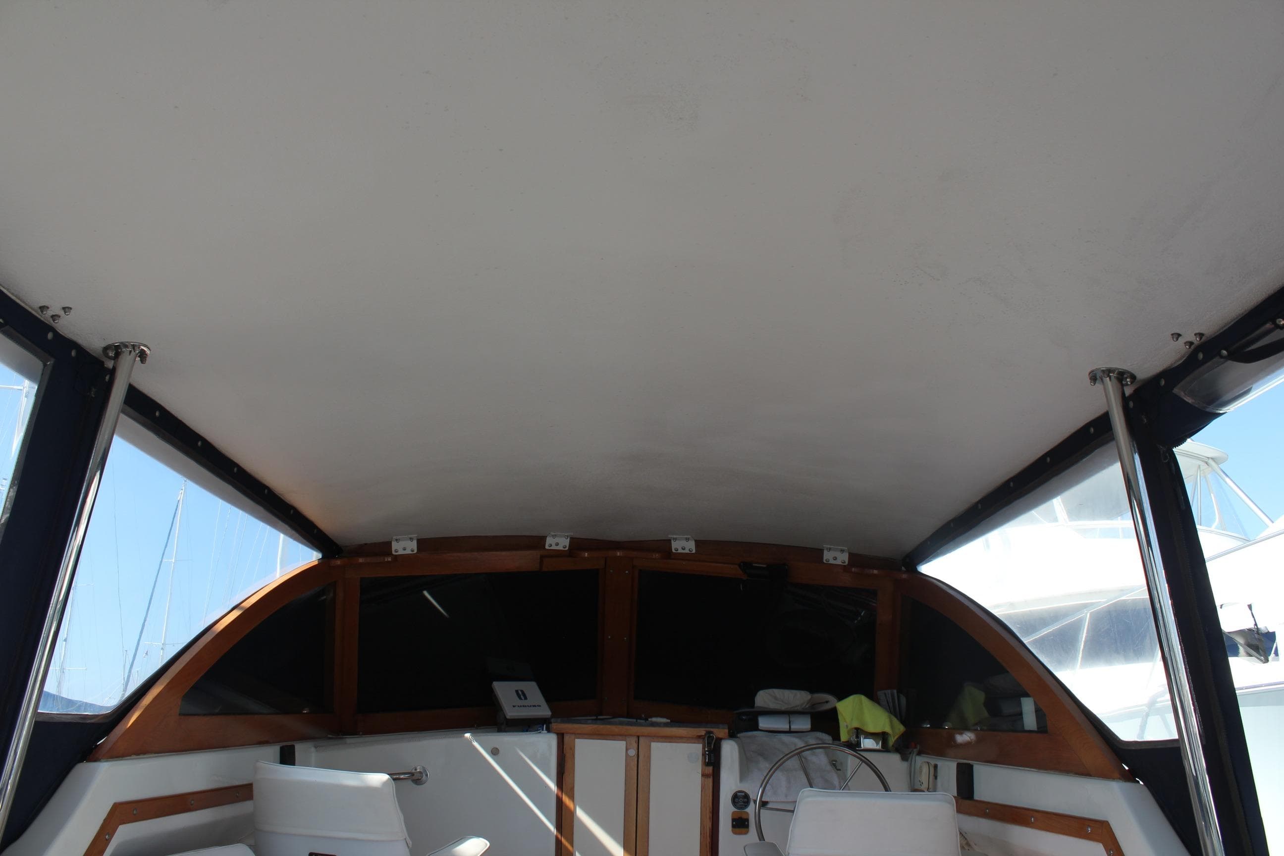 1988 Cape Dory 28 Hardtop interior view with helm and seating area.