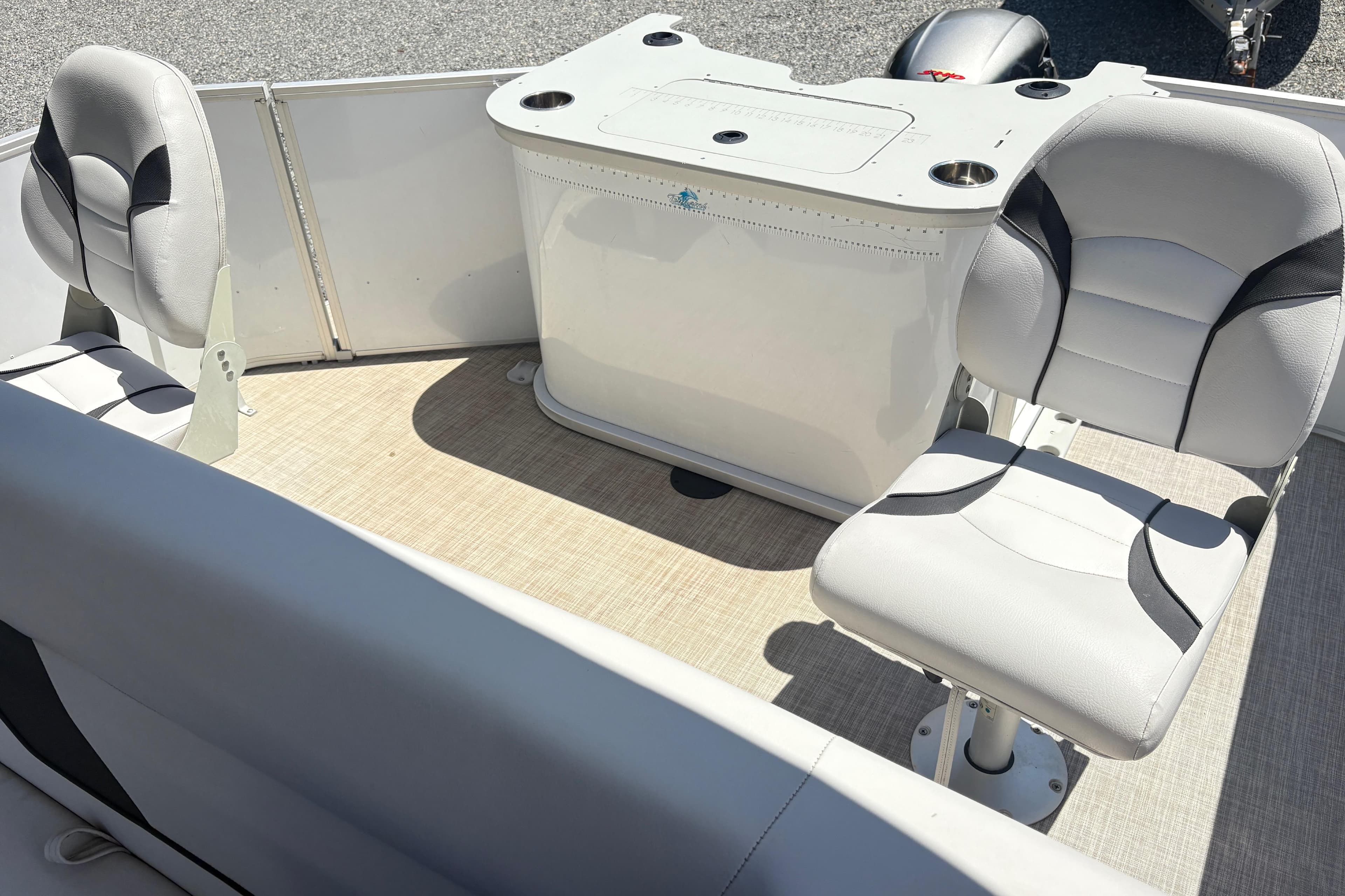 Interior of 2022 SunCatcher Select 22RF pontoon boat with seating and console.