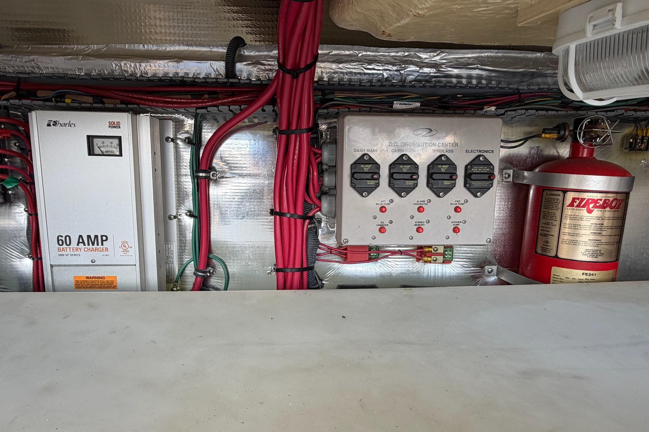 Electrical system of a 2006 Regal Commodore 3560 boat with battery charger and fire extinguisher.