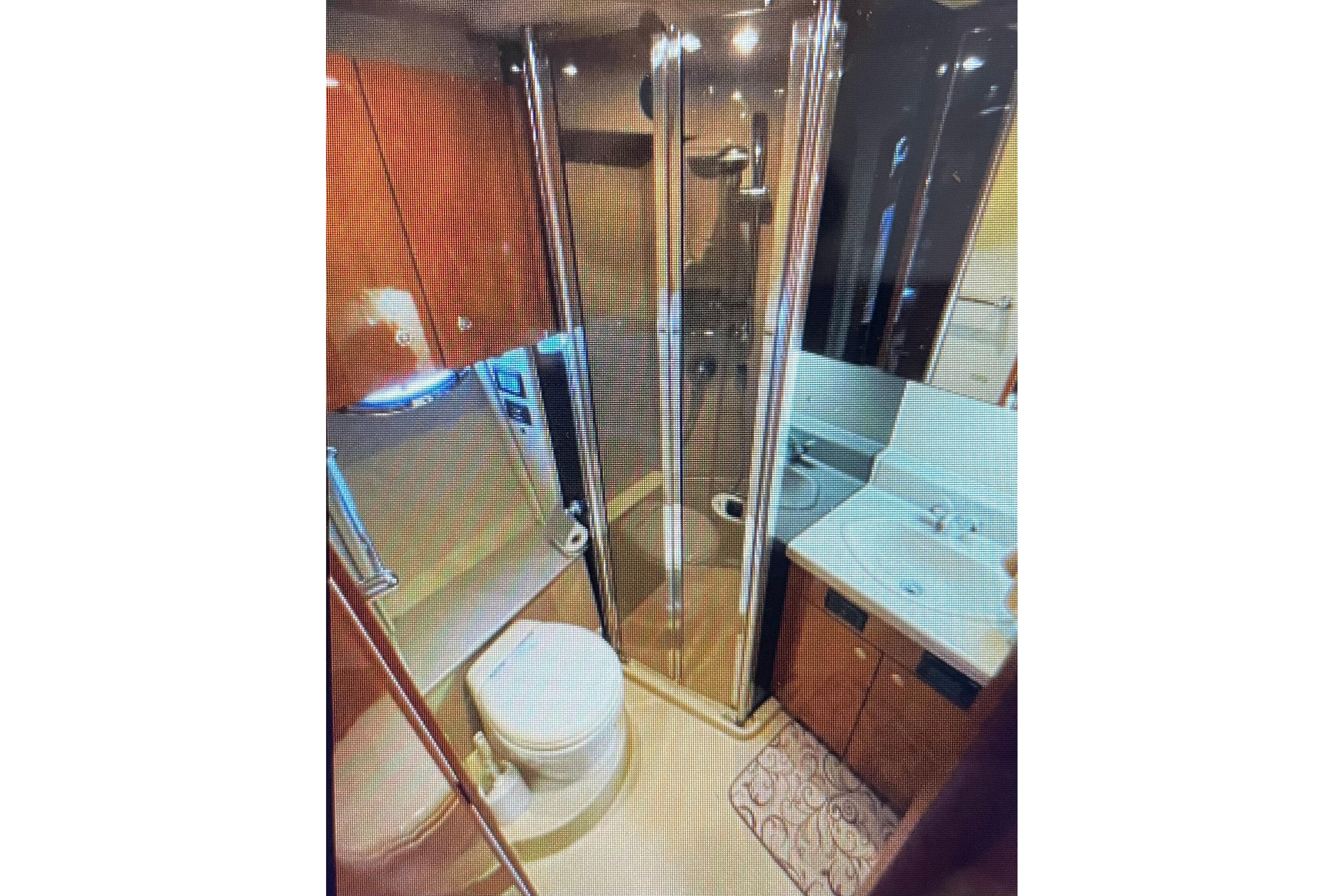 Luxurious bathroom in 2006 Cruisers Yachts 385 Motoryacht with shower and vanity.