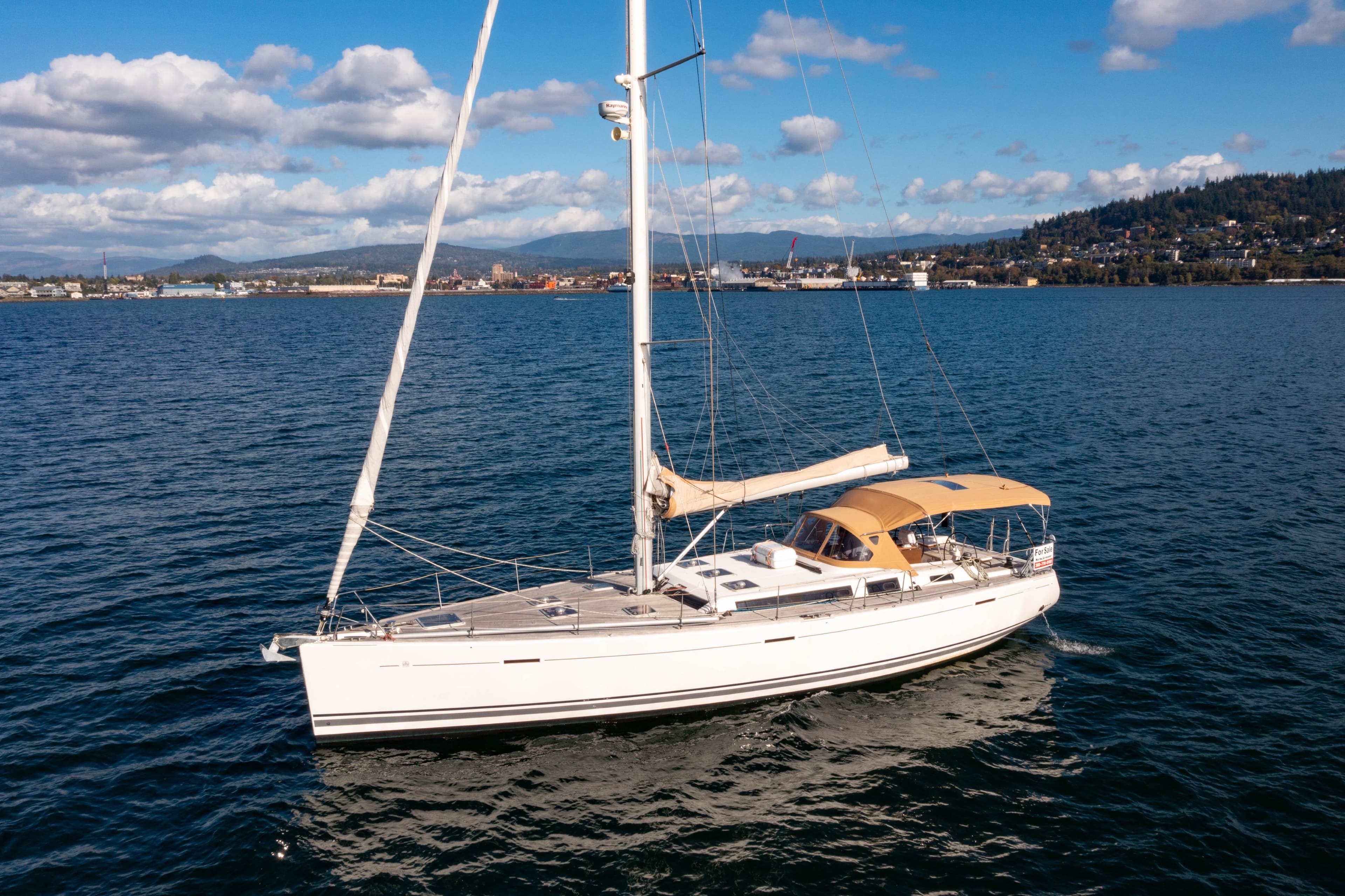 Sailing yacht Dufour 525 Grand Large 2011 on open water, clear sky background.