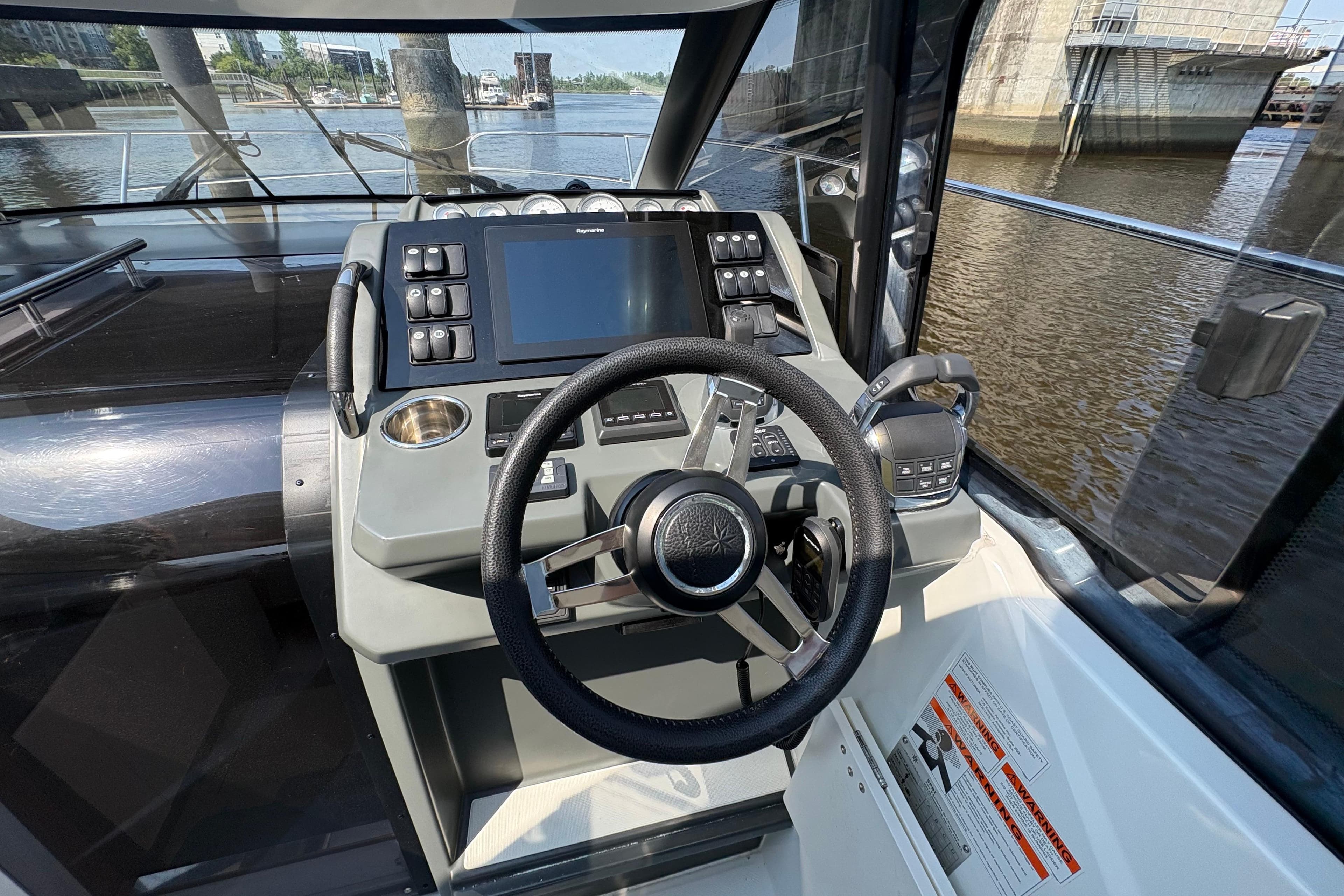 Cockpit view of 2018 Jeanneau Leader 33 boat with steering wheel and control panel.