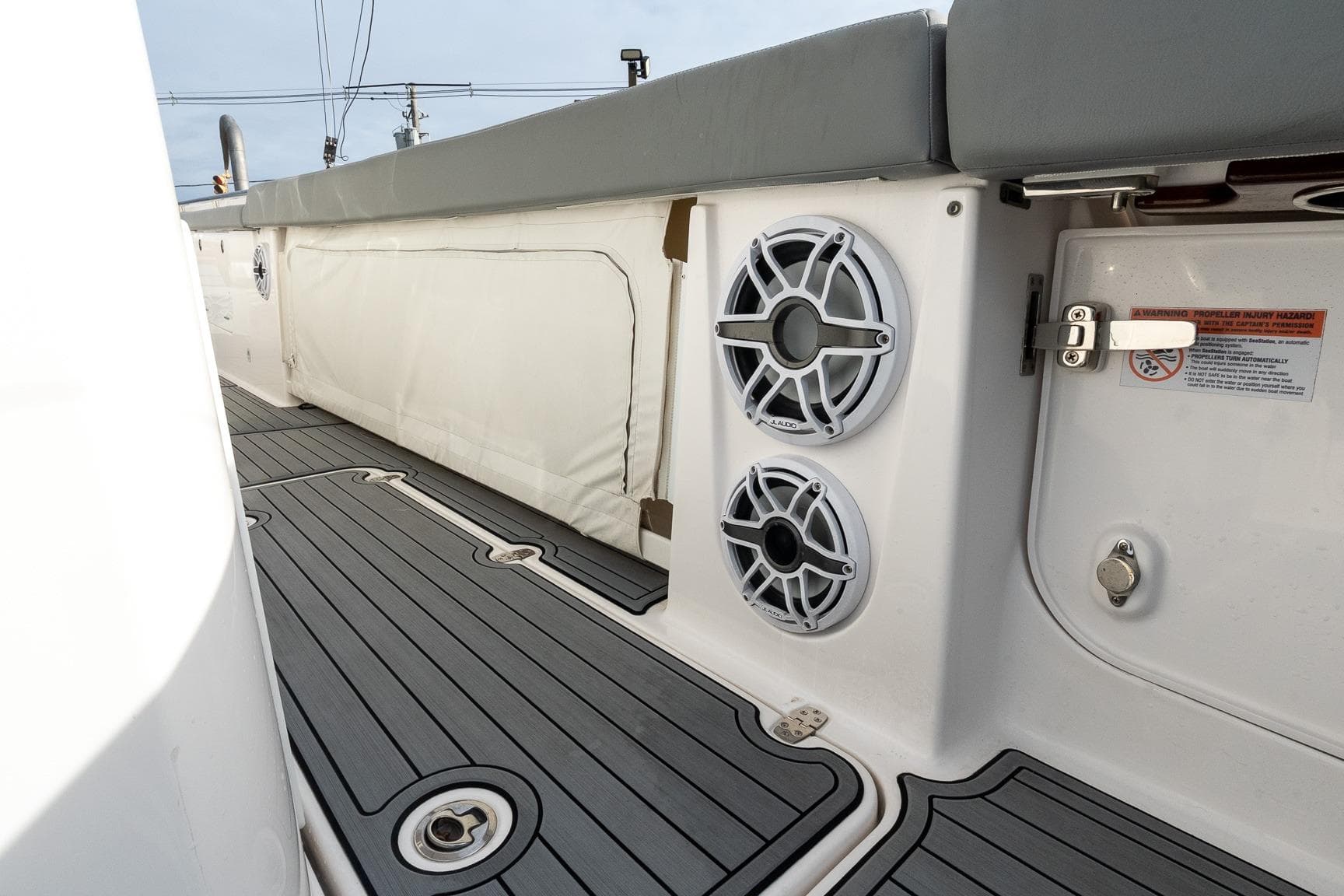 2023 Everglades 455 Center Console boat interior with speakers and cushioned seating.