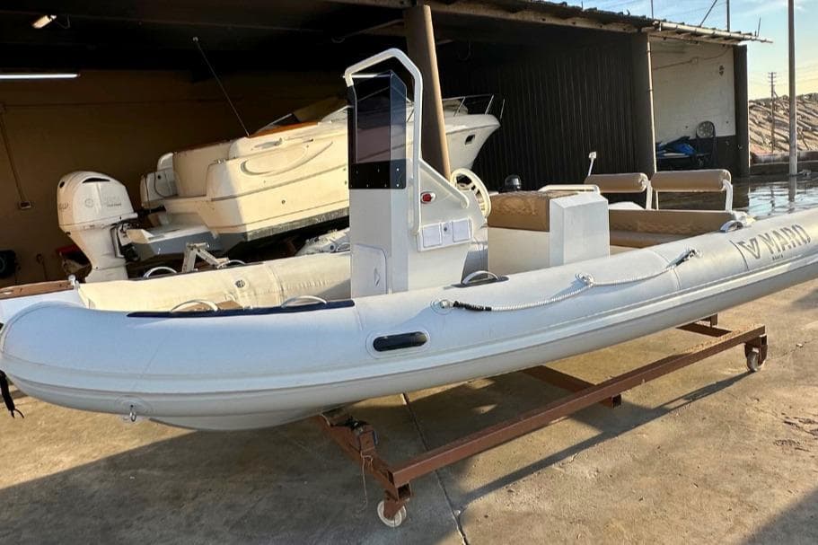 2026 Maro Boats M561 inflatable boat in a garage setting, showcasing sleek design.