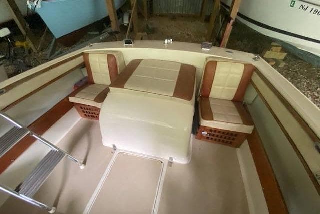 1968 HILINER Sportsman boat interior with beige and brown seating, ladder, and storage compartments.