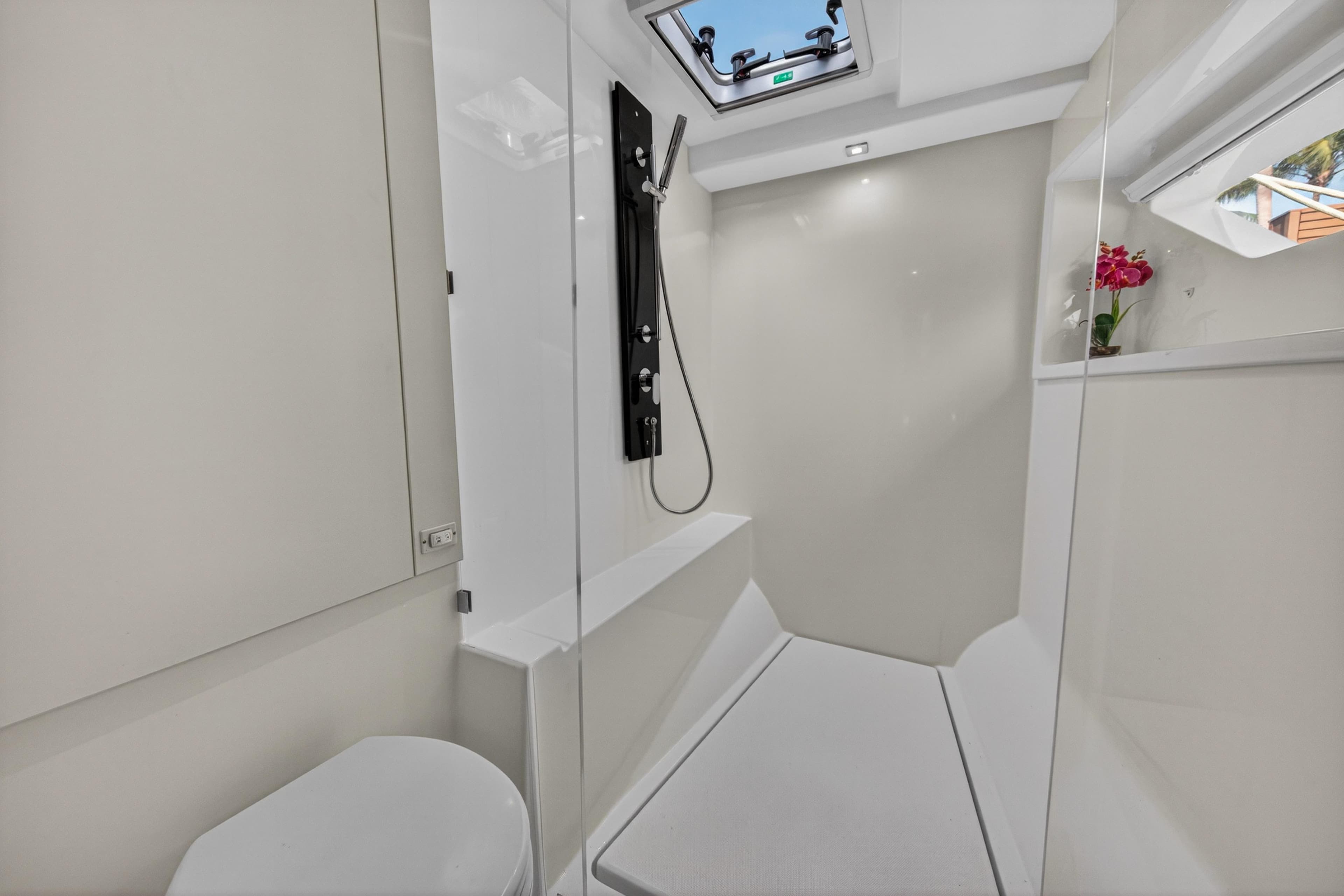Modern bathroom interior on 2022 Leopard 53 Powercat yacht, featuring sleek design and skylight.