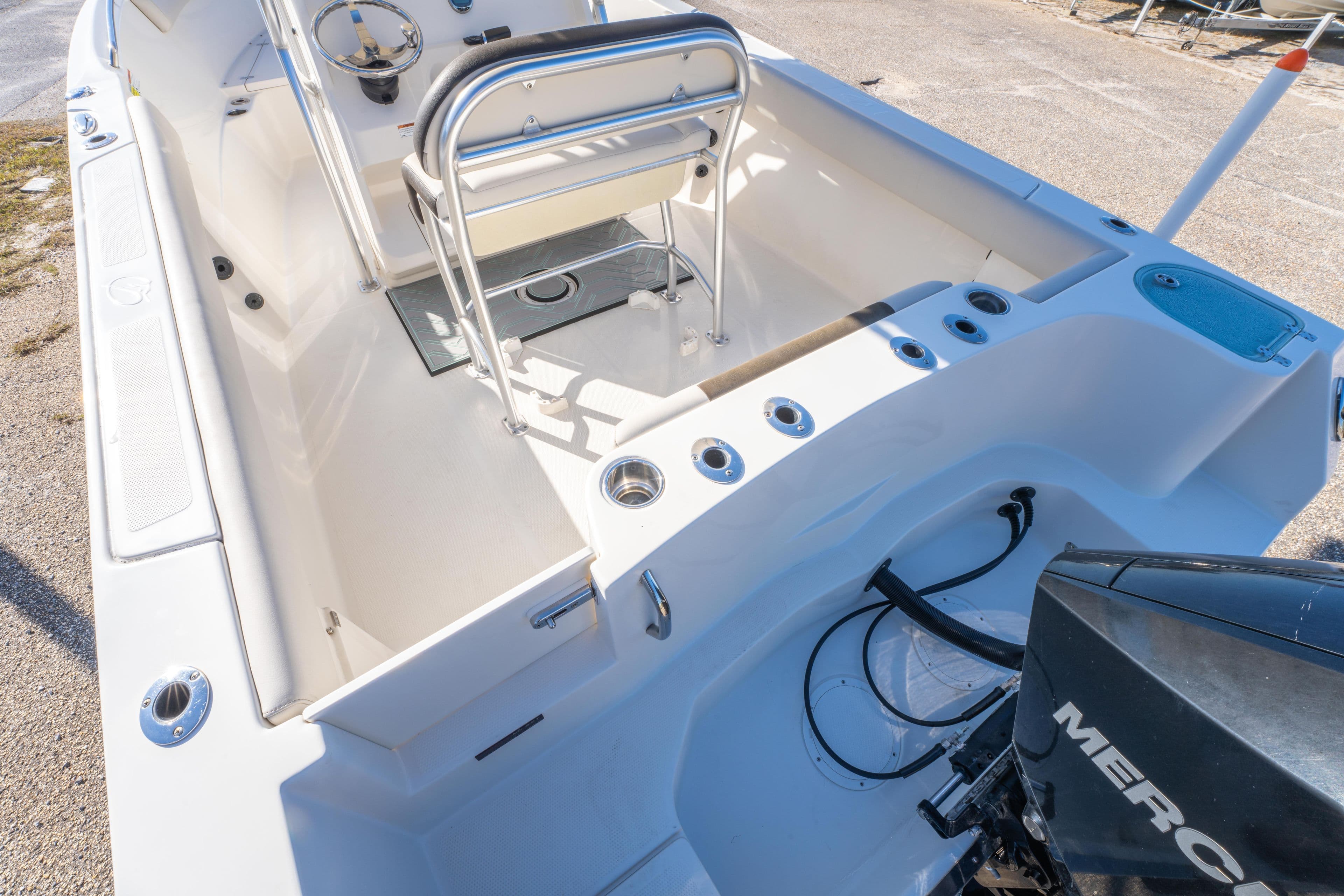 2022 Sailfish 242CC boat interior with seating, steering wheel, and Mercury engine.