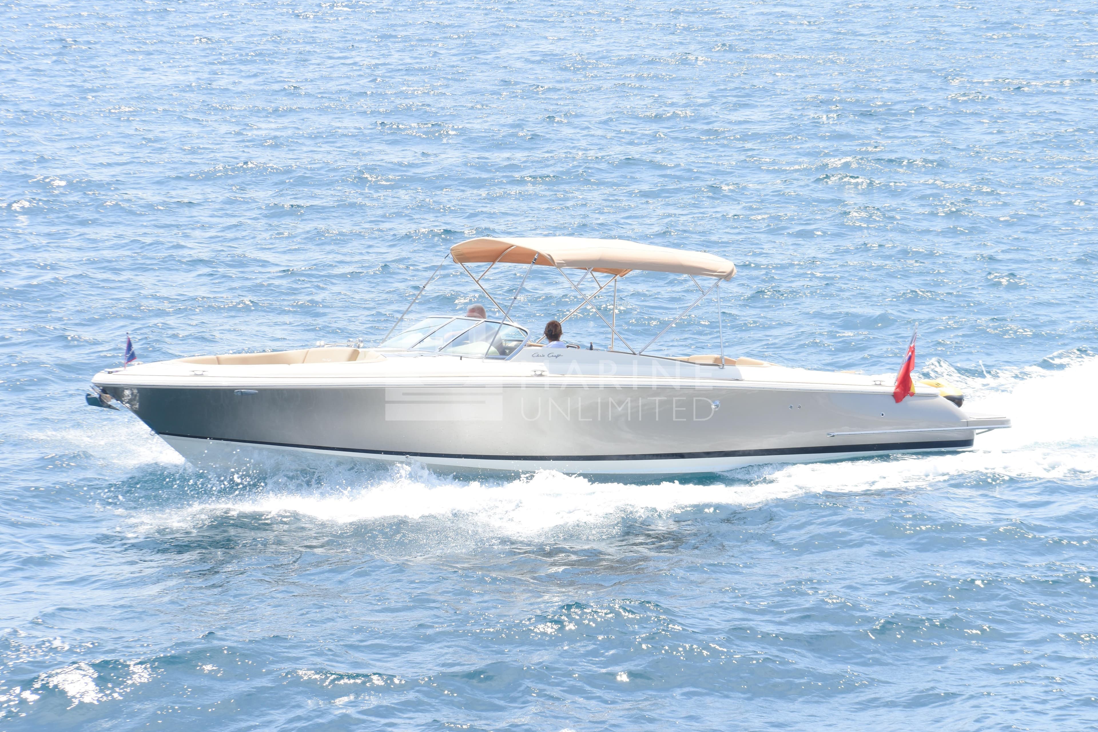 2015 Chris-Craft Launch 32 cruising on open water, side view.
