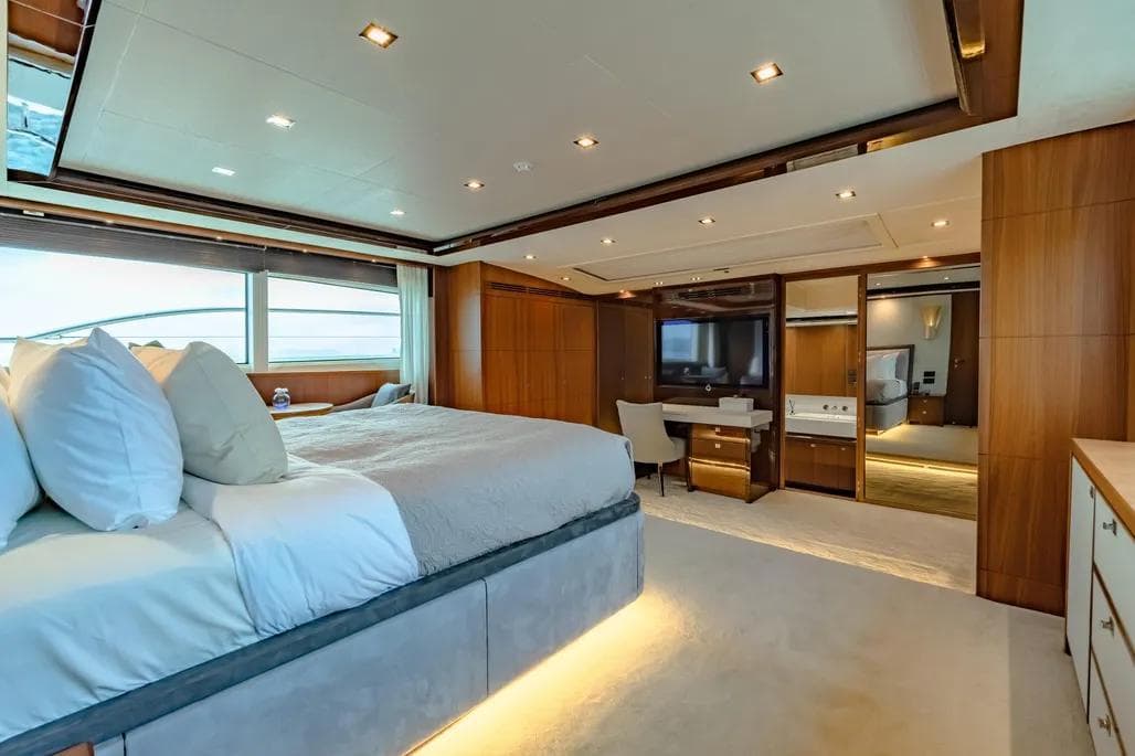 Luxurious bedroom interior on 2013 Princess M Class 32M yacht, featuring elegant wood finishes.