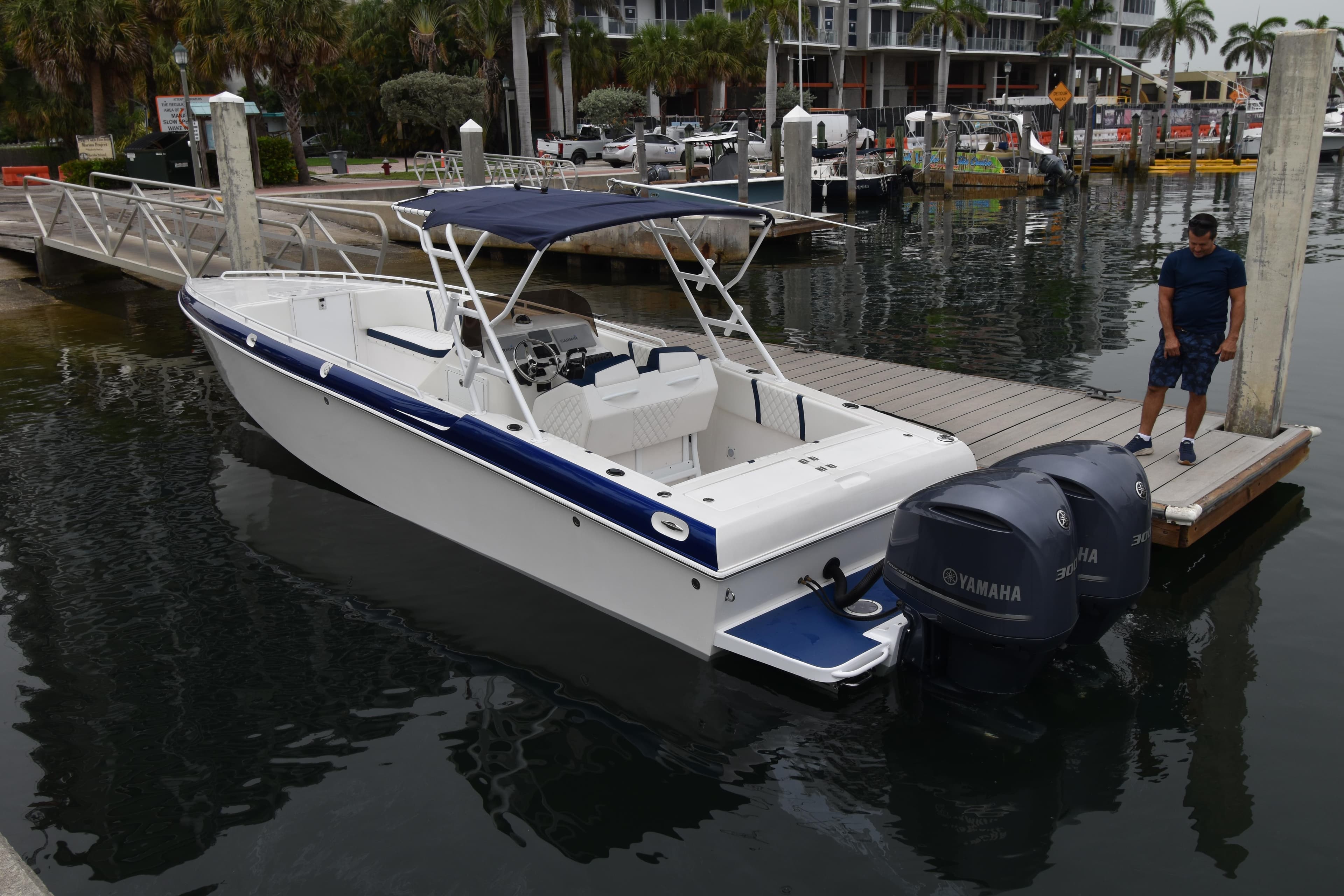 1984 Chris-Craft Scorpion boat docked with Yamaha engines, marina background.