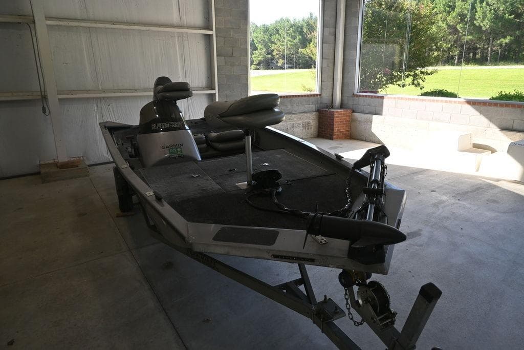 2011 Alumacraft Pro 175 boat in a garage, featuring a Garmin fish finder.