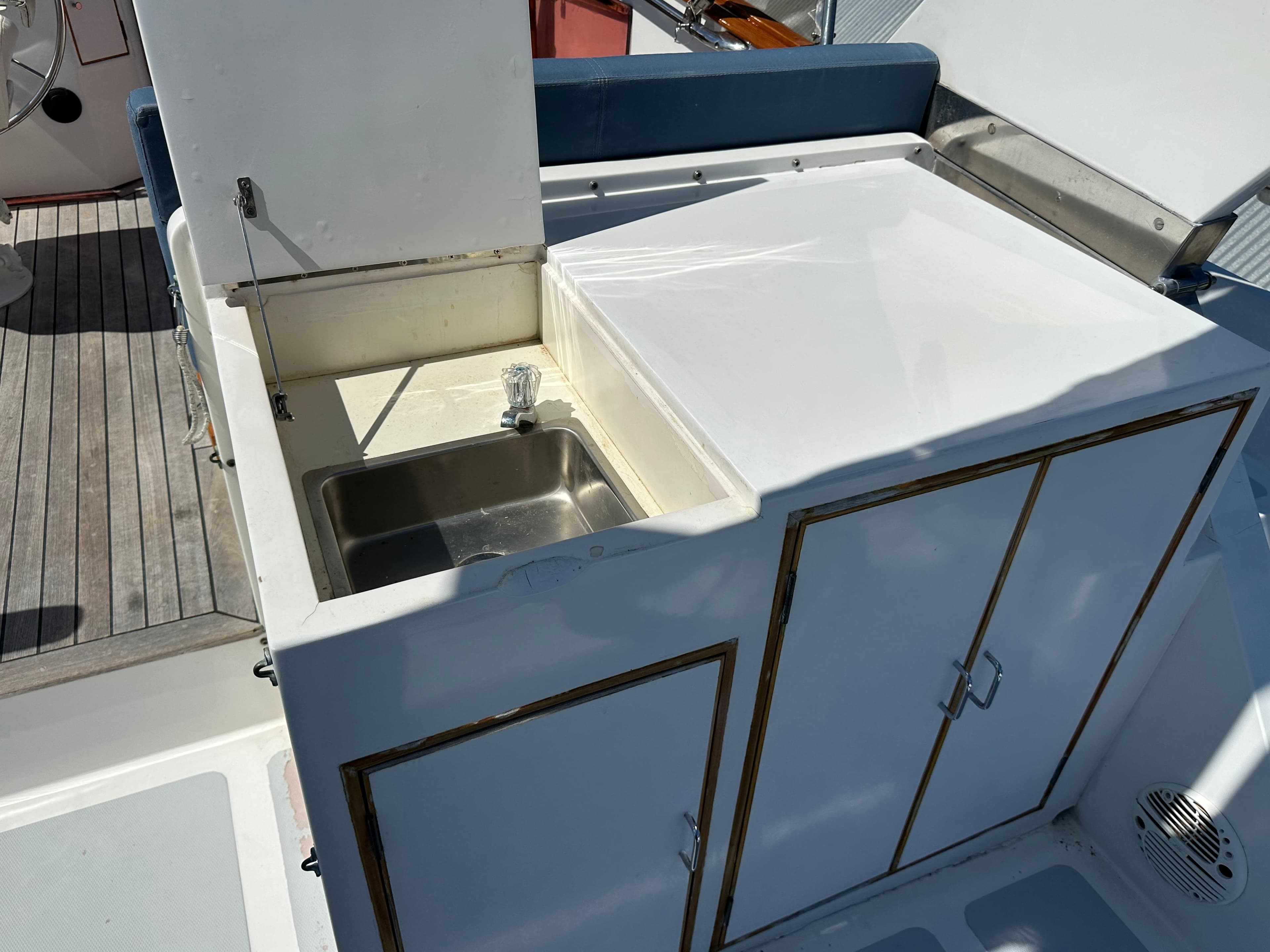 1985 Ocean Alexander Pilothouse yacht sink and storage area on deck.