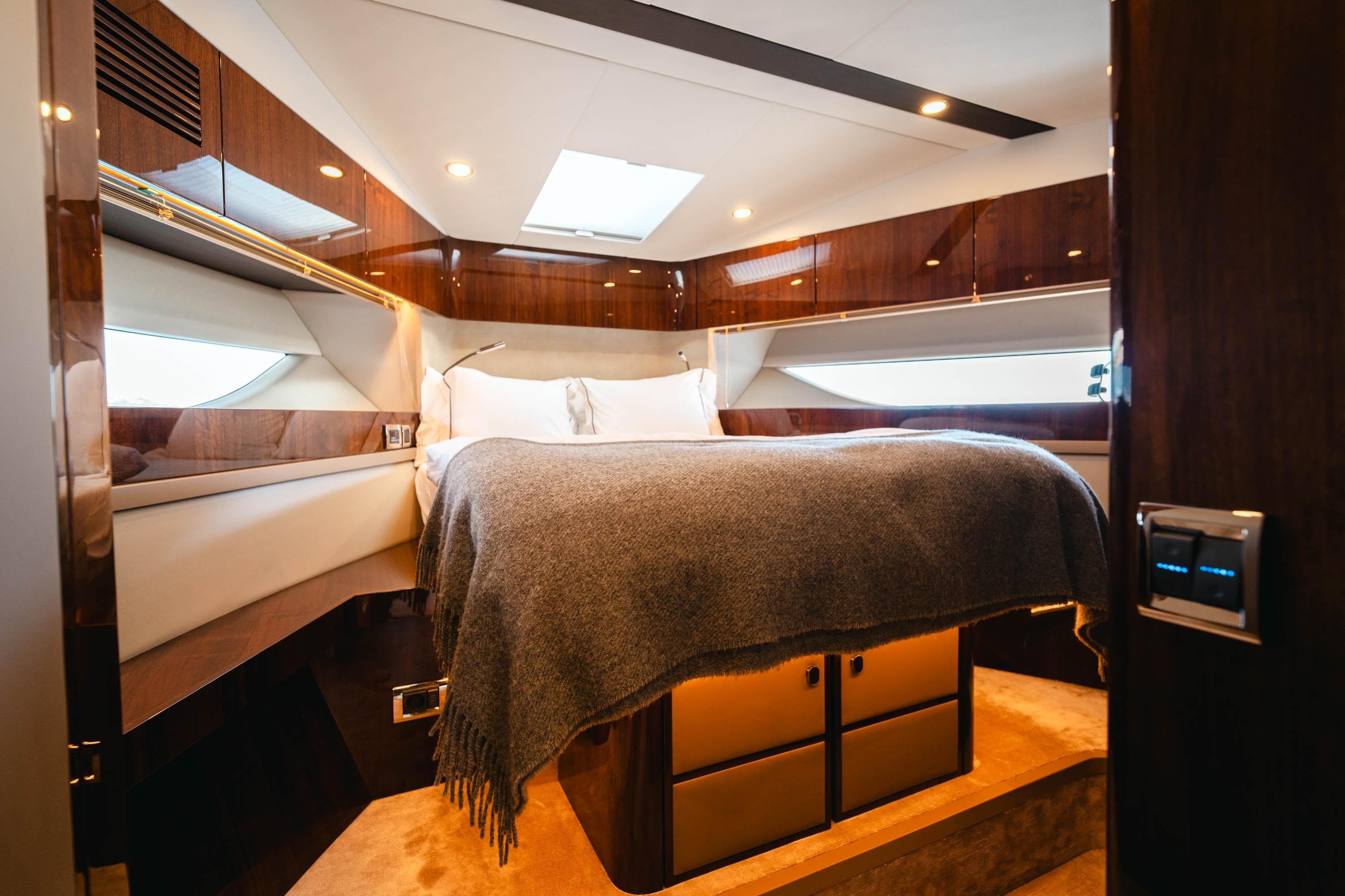 Luxurious cabin interior of 2020 Fairline Targa 45 Open yacht with elegant wood finishes.