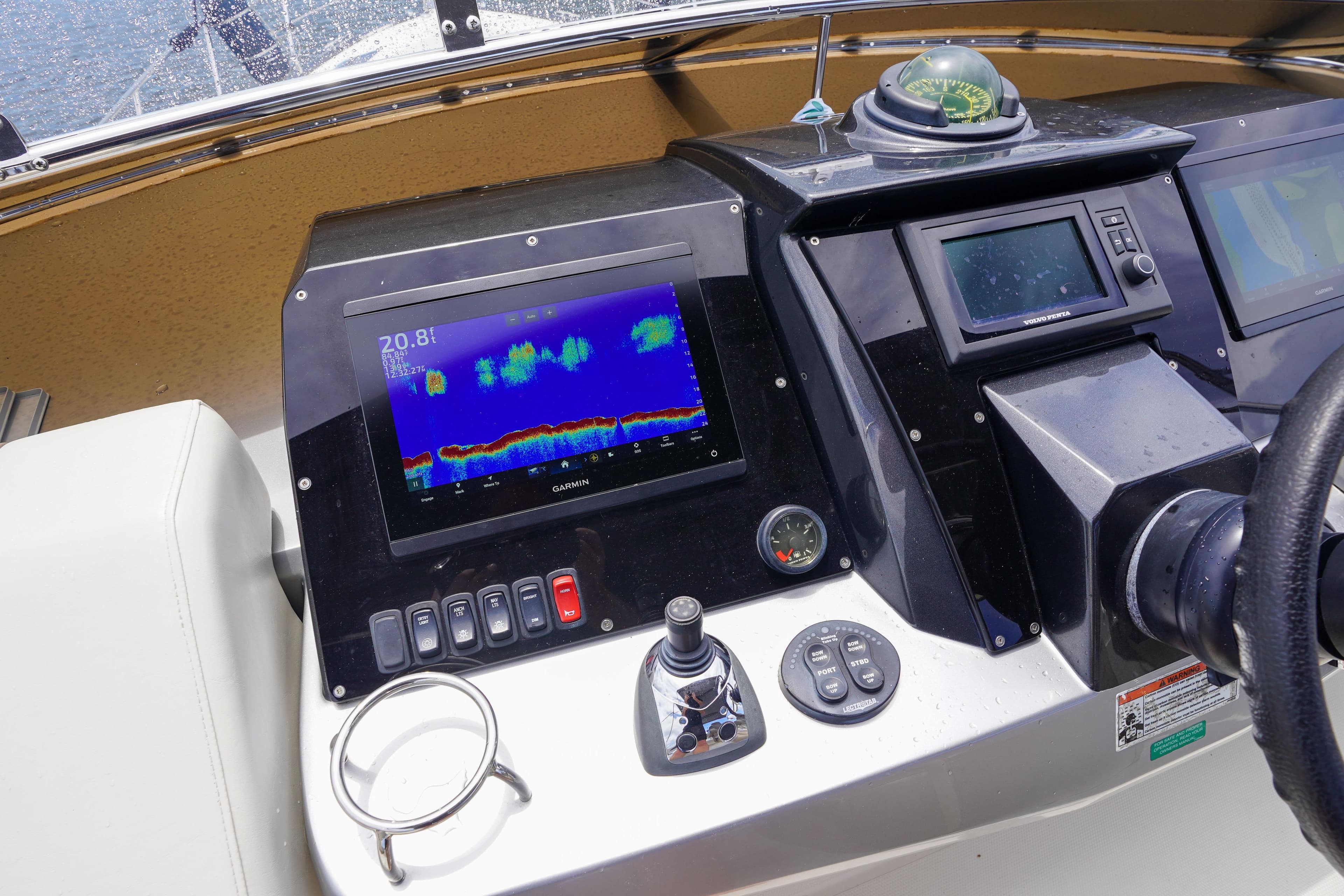 Control panel of a 2009 Marquis 500 Sport Bridge yacht with navigation equipment.