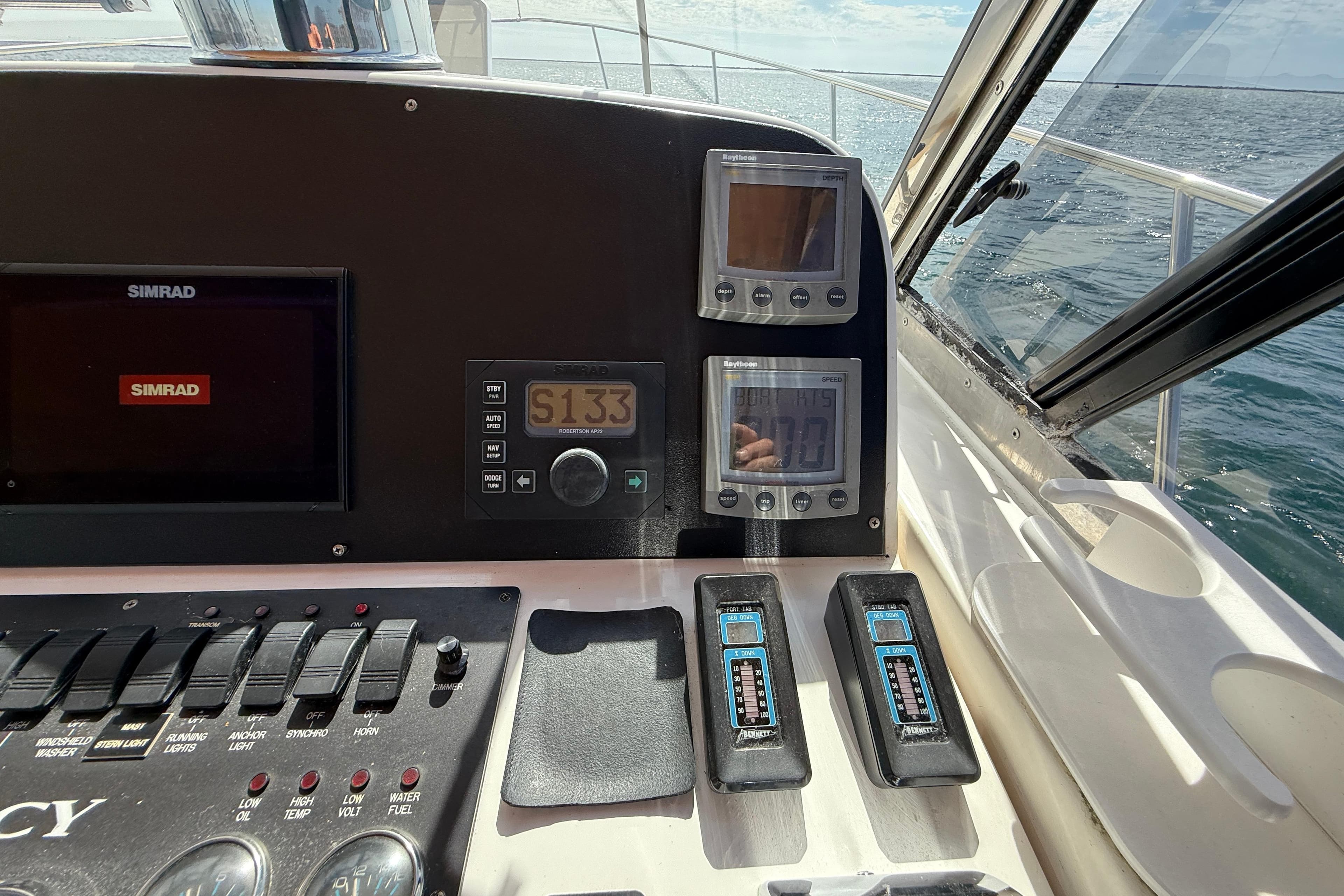 Control panel of a 1999 Legacy 40 boat with Simrad navigation system.