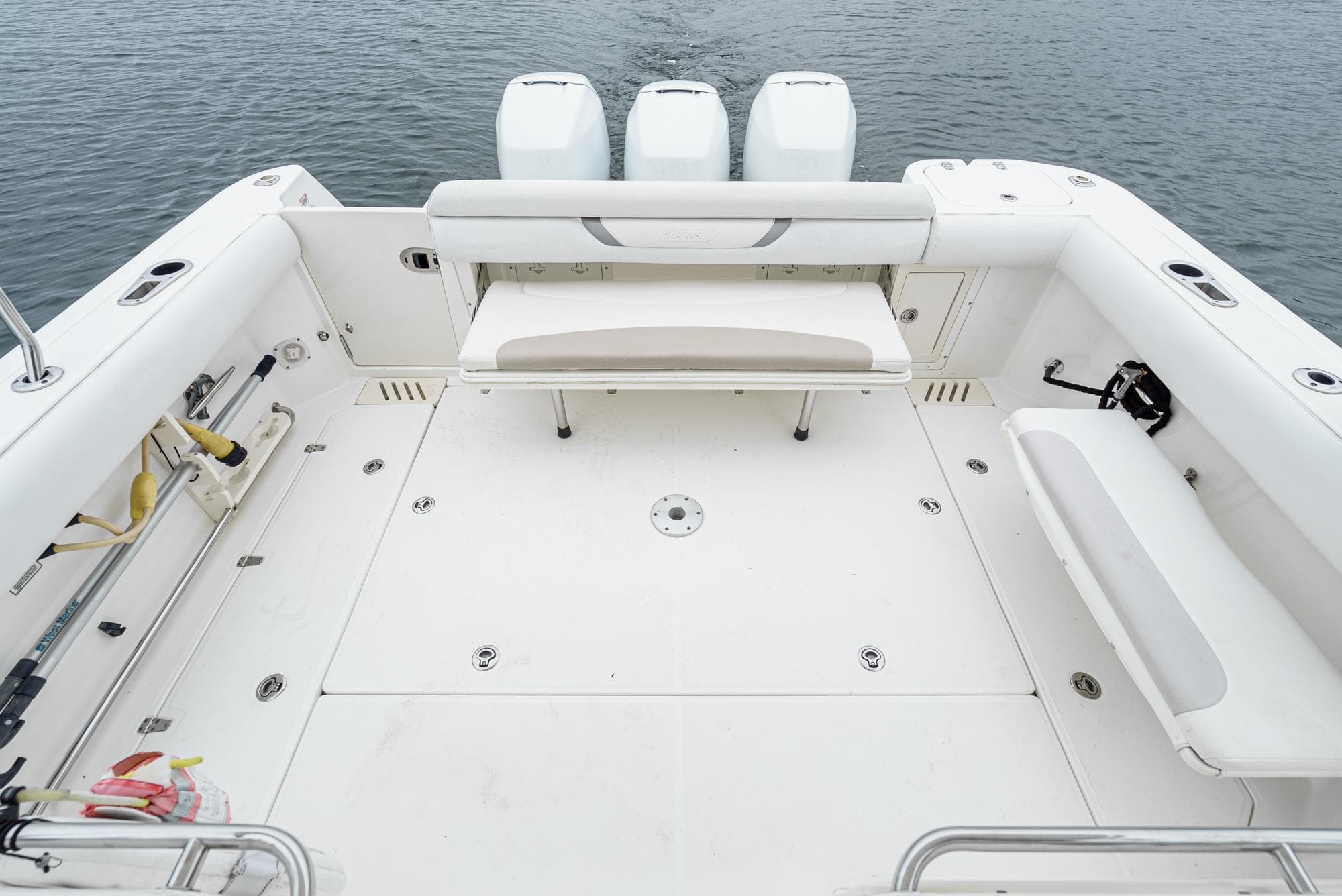 2008 Boston Whaler 345 Conquest boat deck with seating and triple engines.