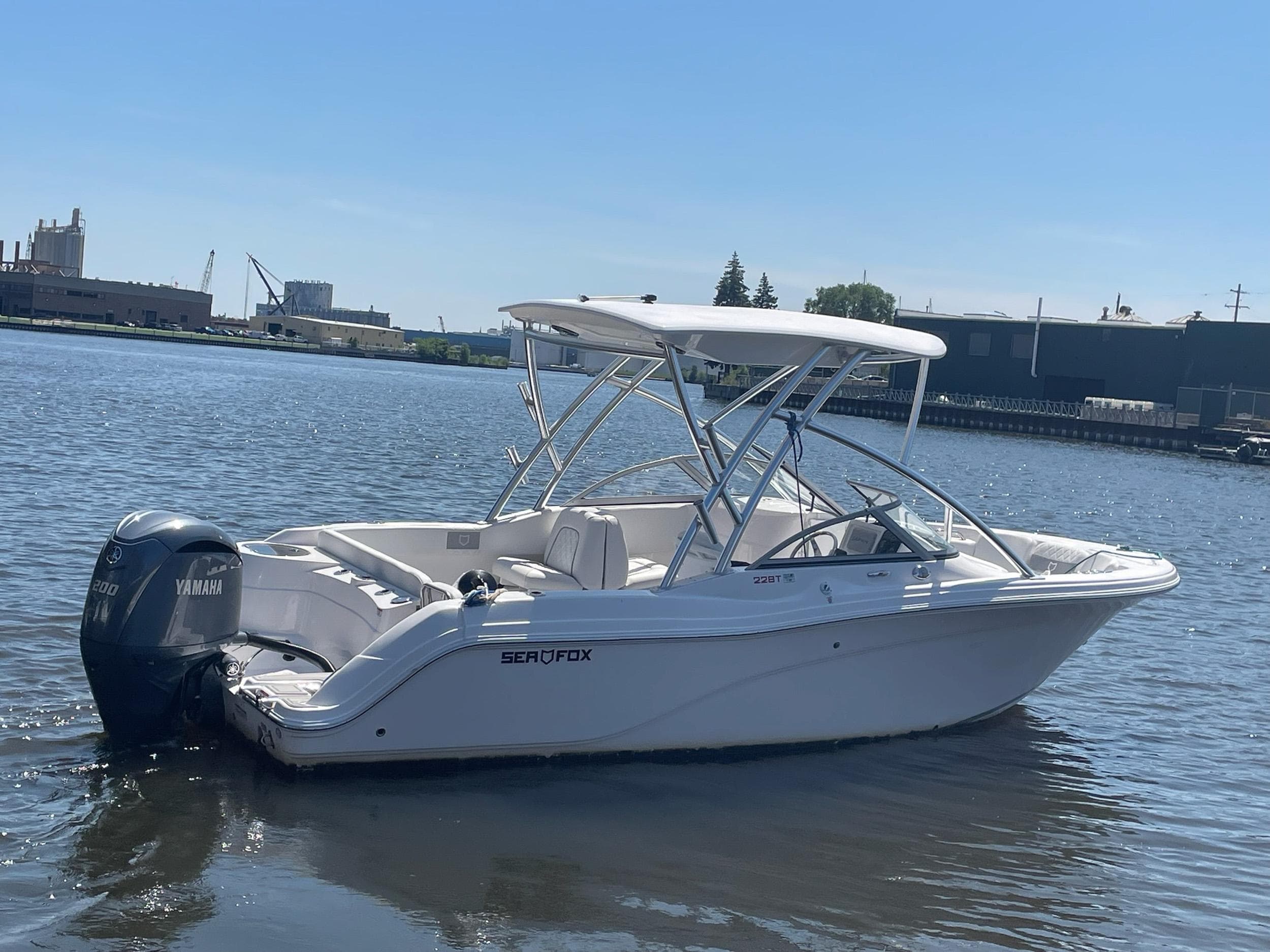 2024 Sea Fox 228 Traveler boat on calm water with Yamaha outboard motor.