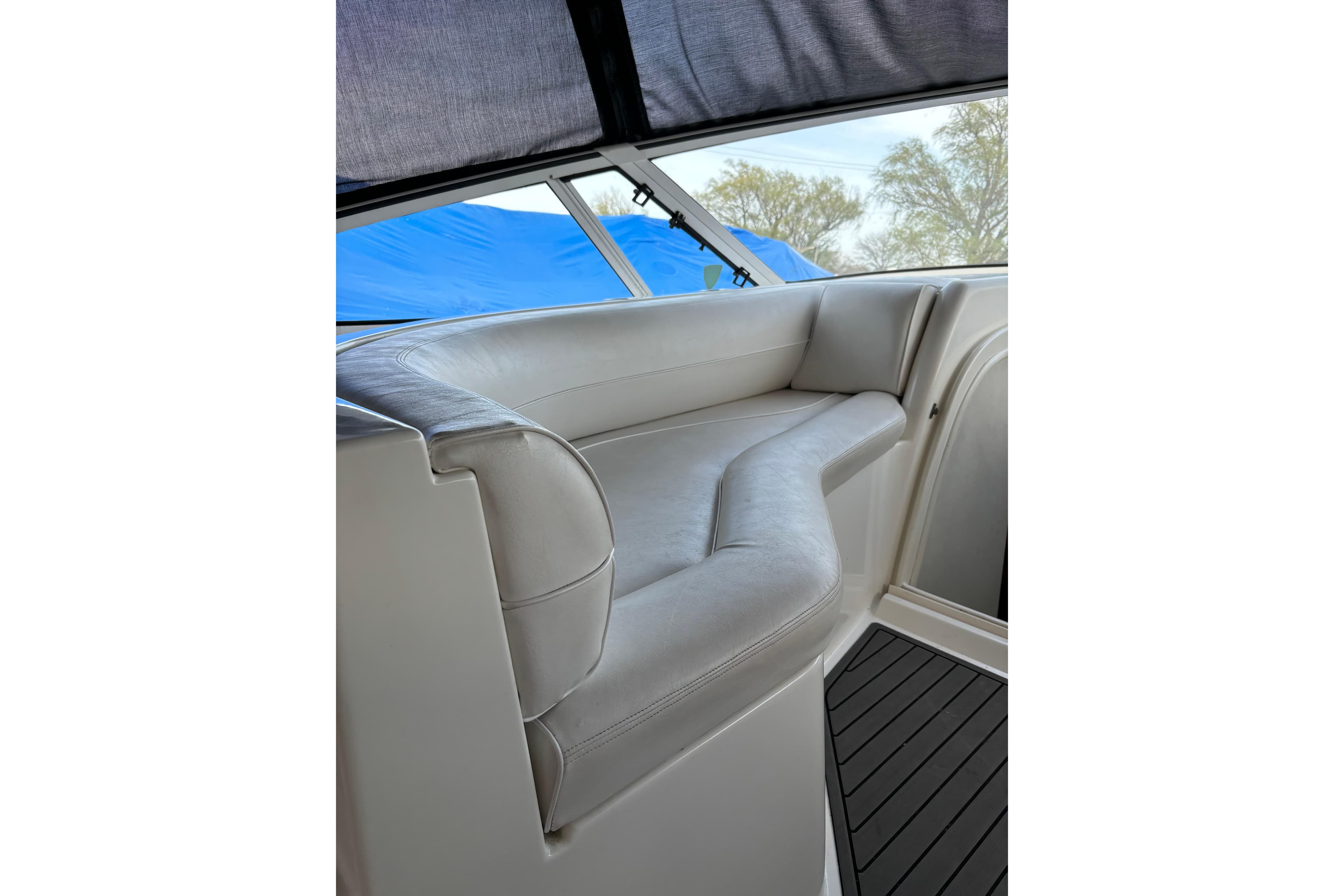 Luxurious seating on a 2000 Cruisers 3870 yacht, featuring sleek white upholstery.
