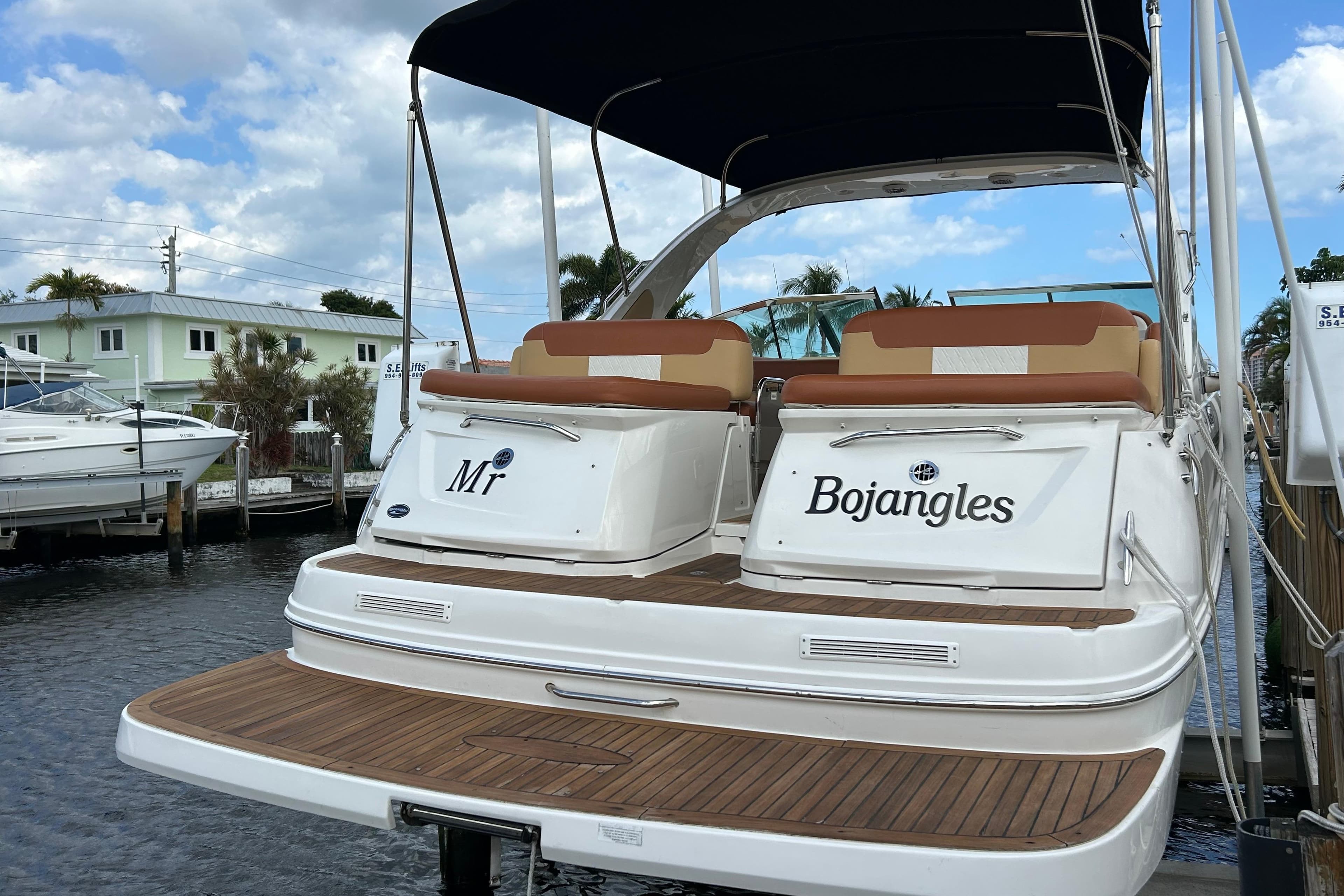 2014 Sea Ray 370 Venture boat docked, featuring teak deck and dual seating.