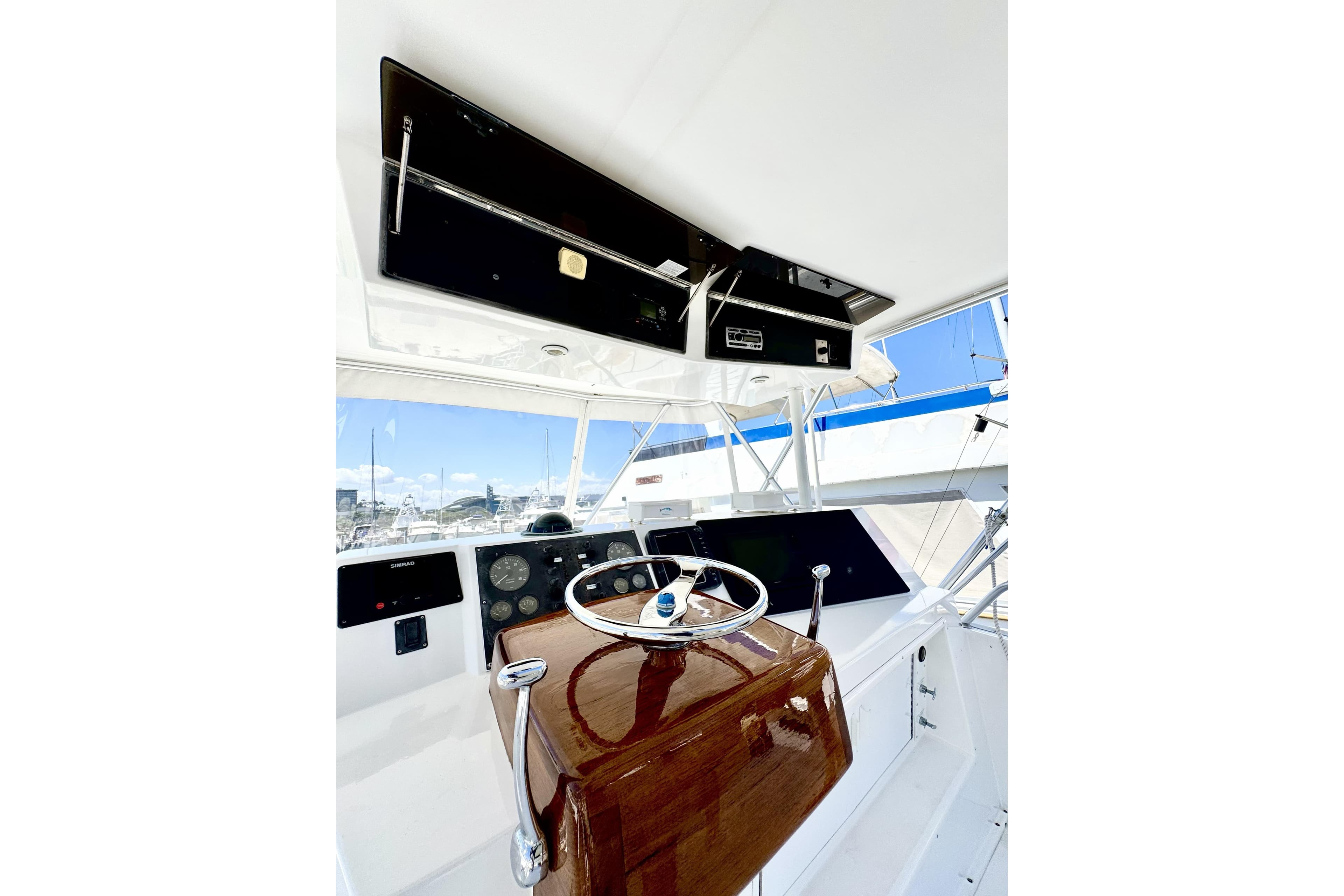 1999 Viking 43 Convertible yacht helm with polished wood and modern controls.