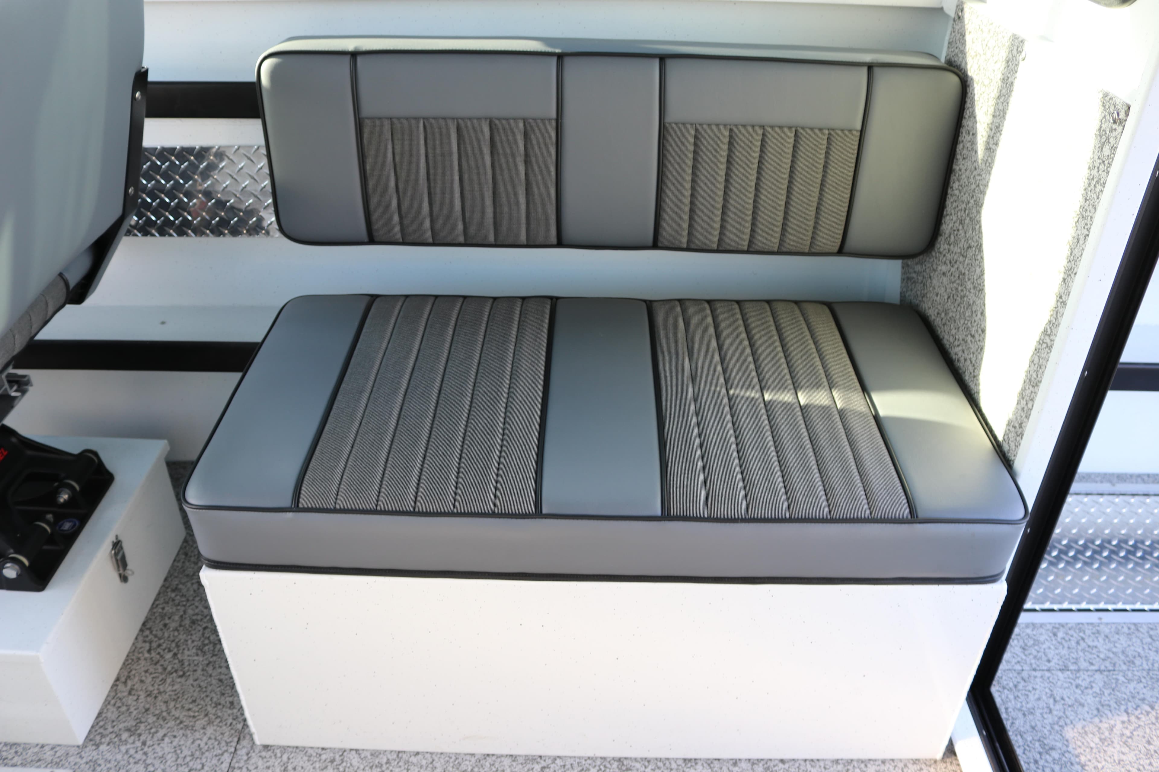 Gray cushioned seating in 2026 Alumaweld Horizon 26 boat interior.