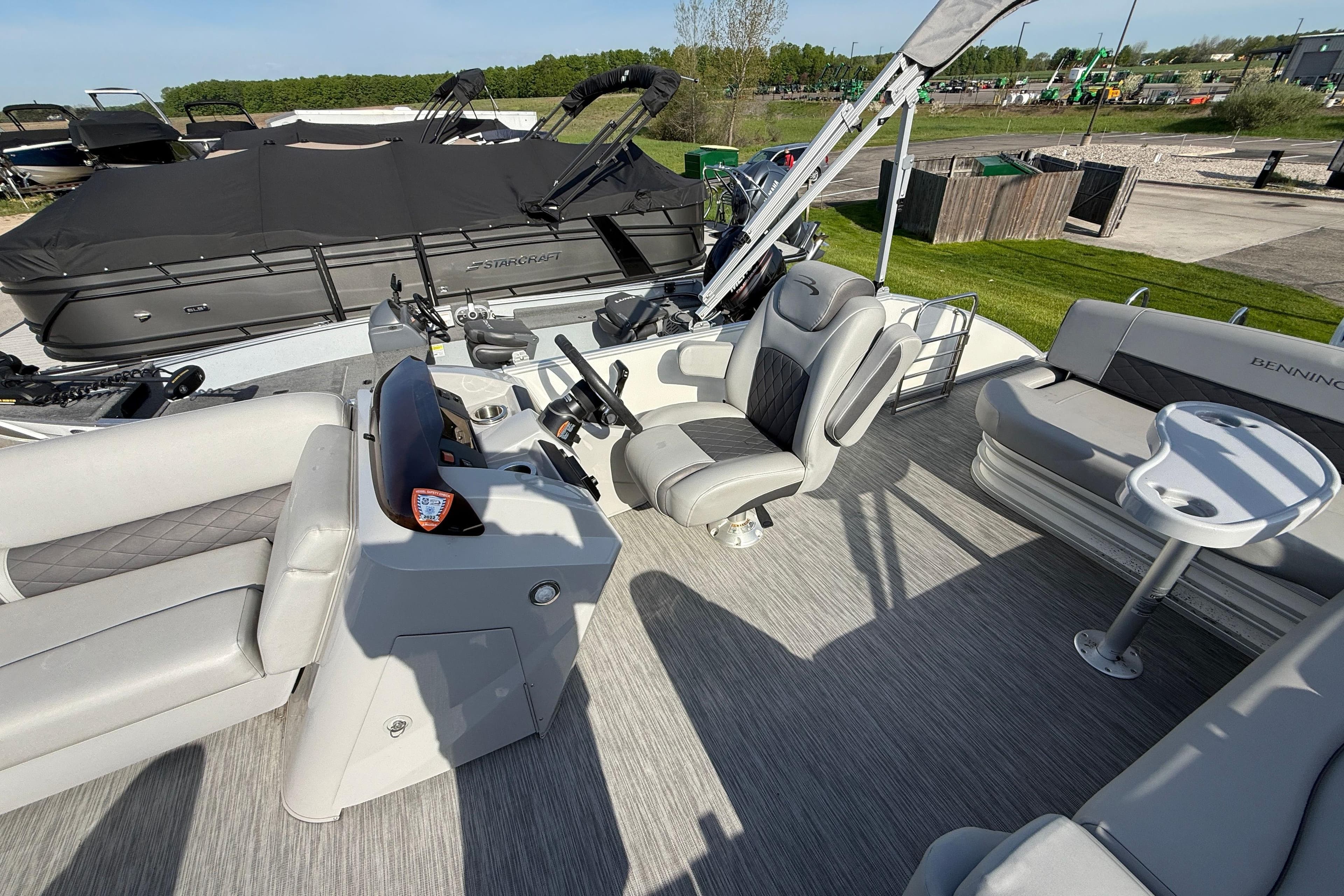 2021 Bennington 25 SSBXSD pontoon boat interior with plush seating and modern helm.