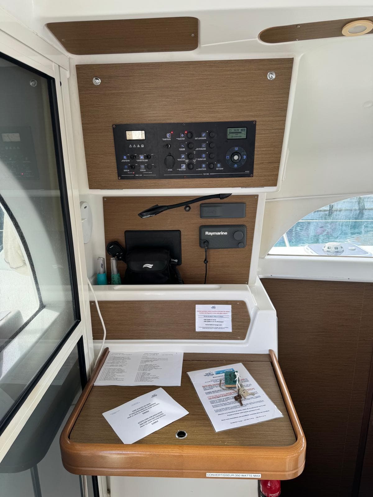 Control panel and documents inside a 2018 Lagoon LAGOON 380 catamaran.