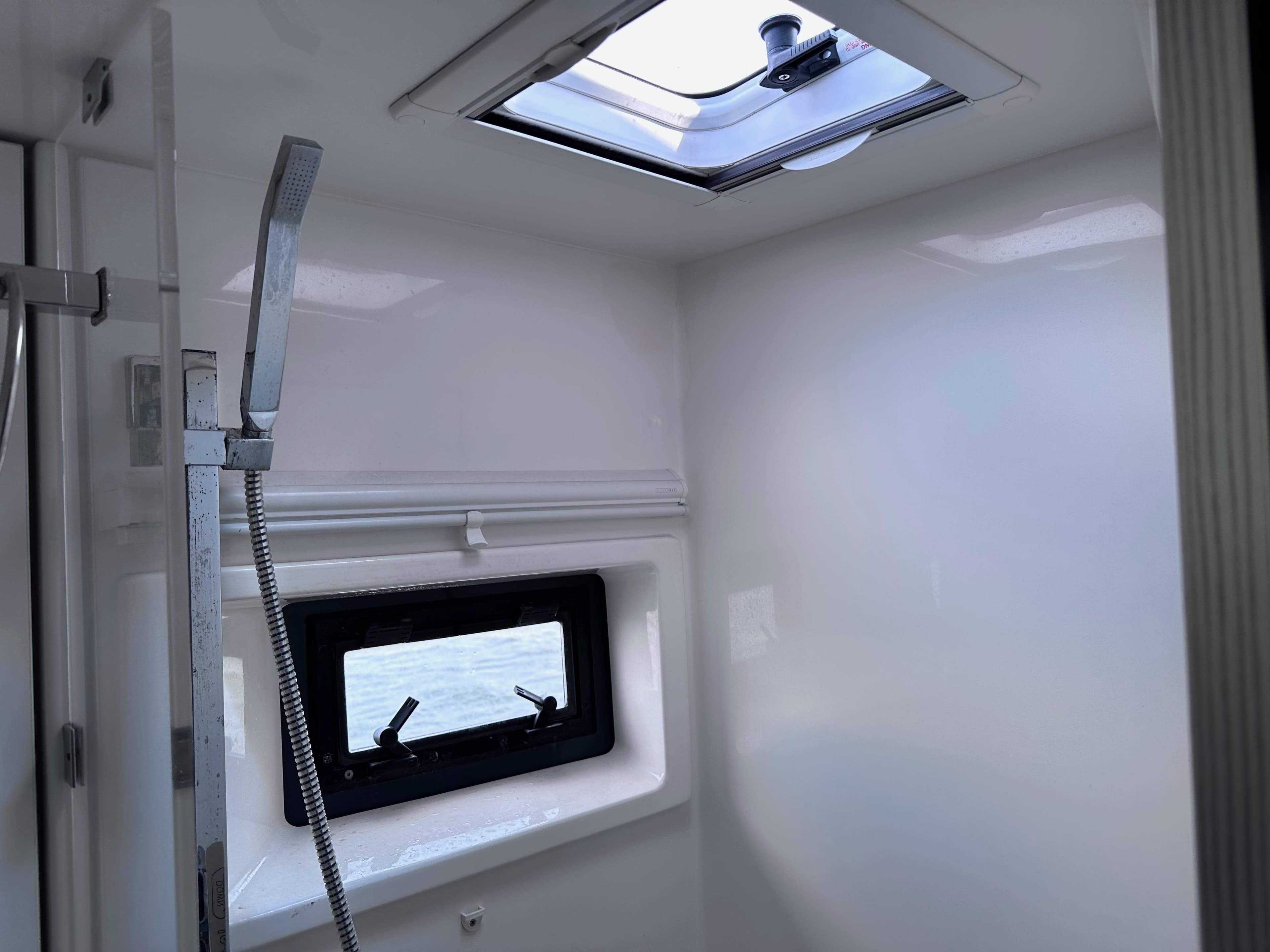 Interior of a 2019 Leopard 45 yacht bathroom with shower and window.