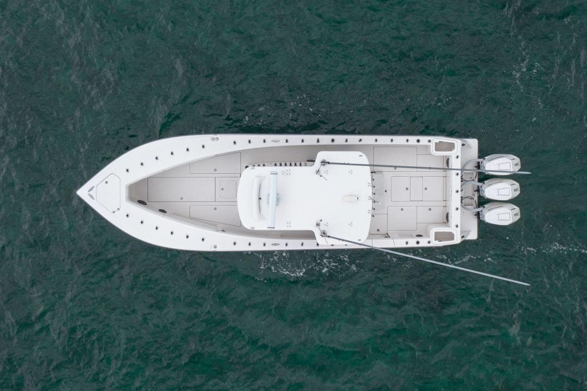 Overhead view of 2024 SeaVee 370Z boat on water, featuring triple outboard engines.