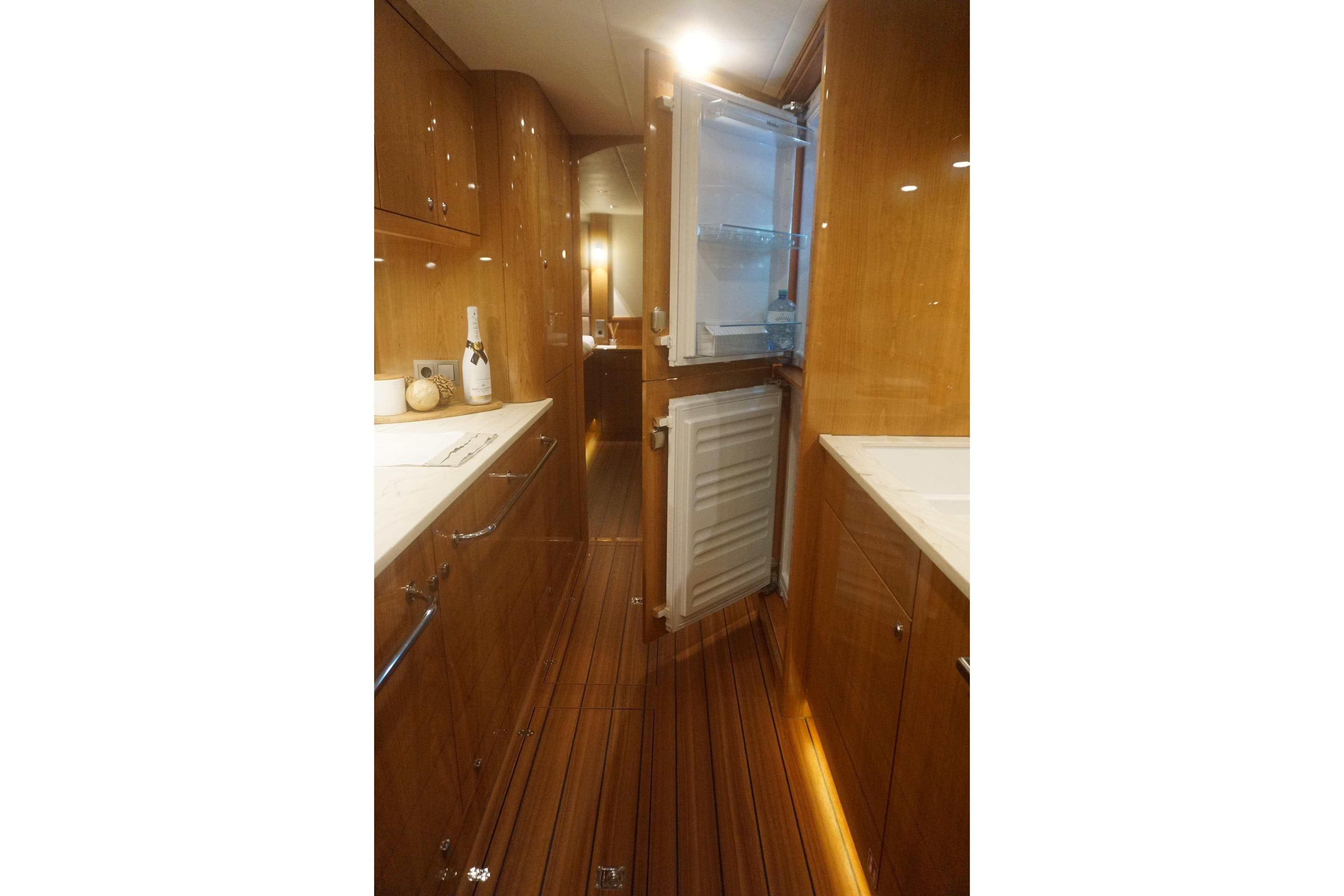 Luxurious interior of 2026 Elling E6 yacht with wooden cabinetry and modern amenities.