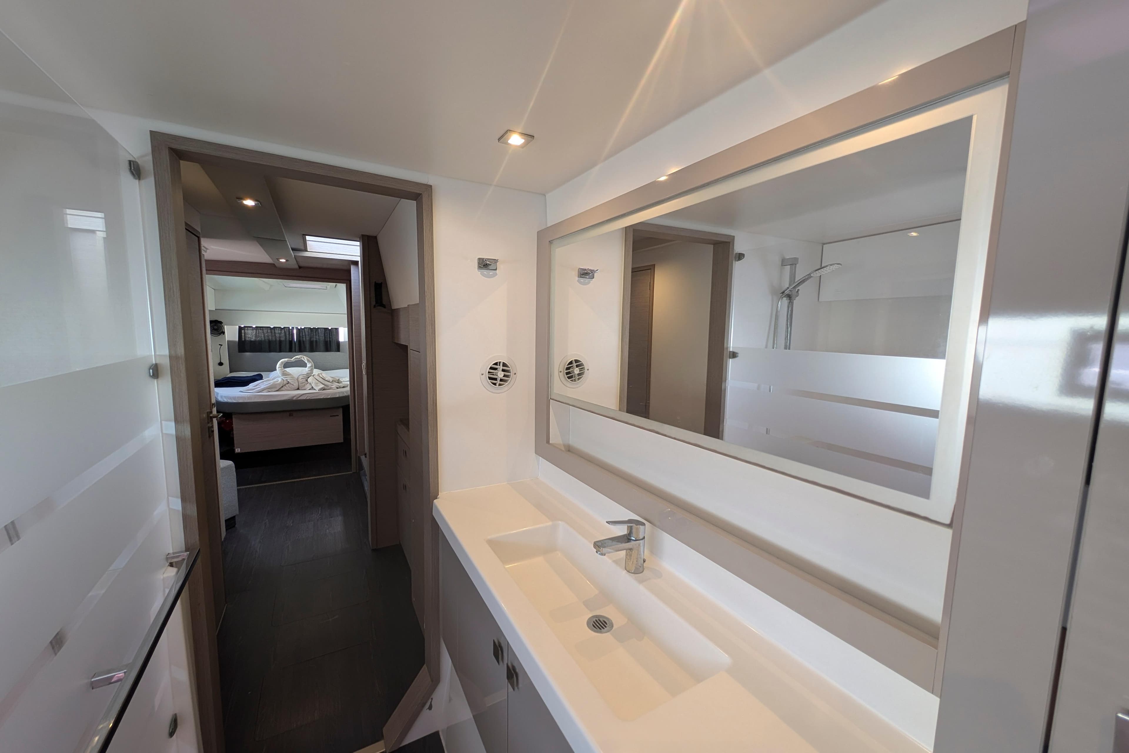 Modern bathroom interior on 2020 Fountaine Pajot Astrea 42 catamaran, featuring sleek design and spacious layout.