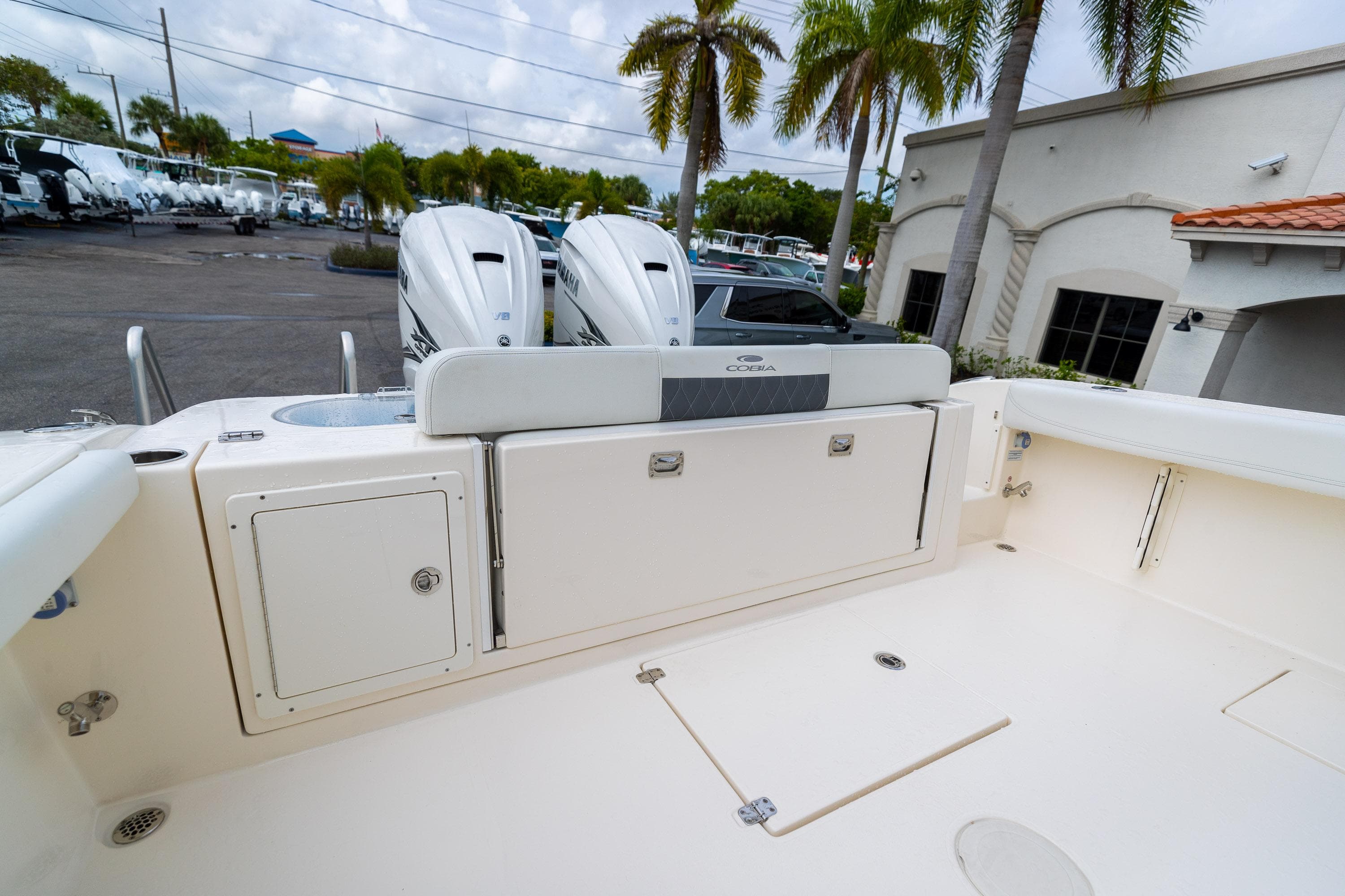 2023 Cobia 350 Center Console boat deck with dual engines and storage compartments.