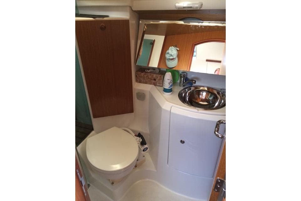 Compact bathroom in 2007 Jeanneau Sun Odyssey 36i yacht with sink and toilet.