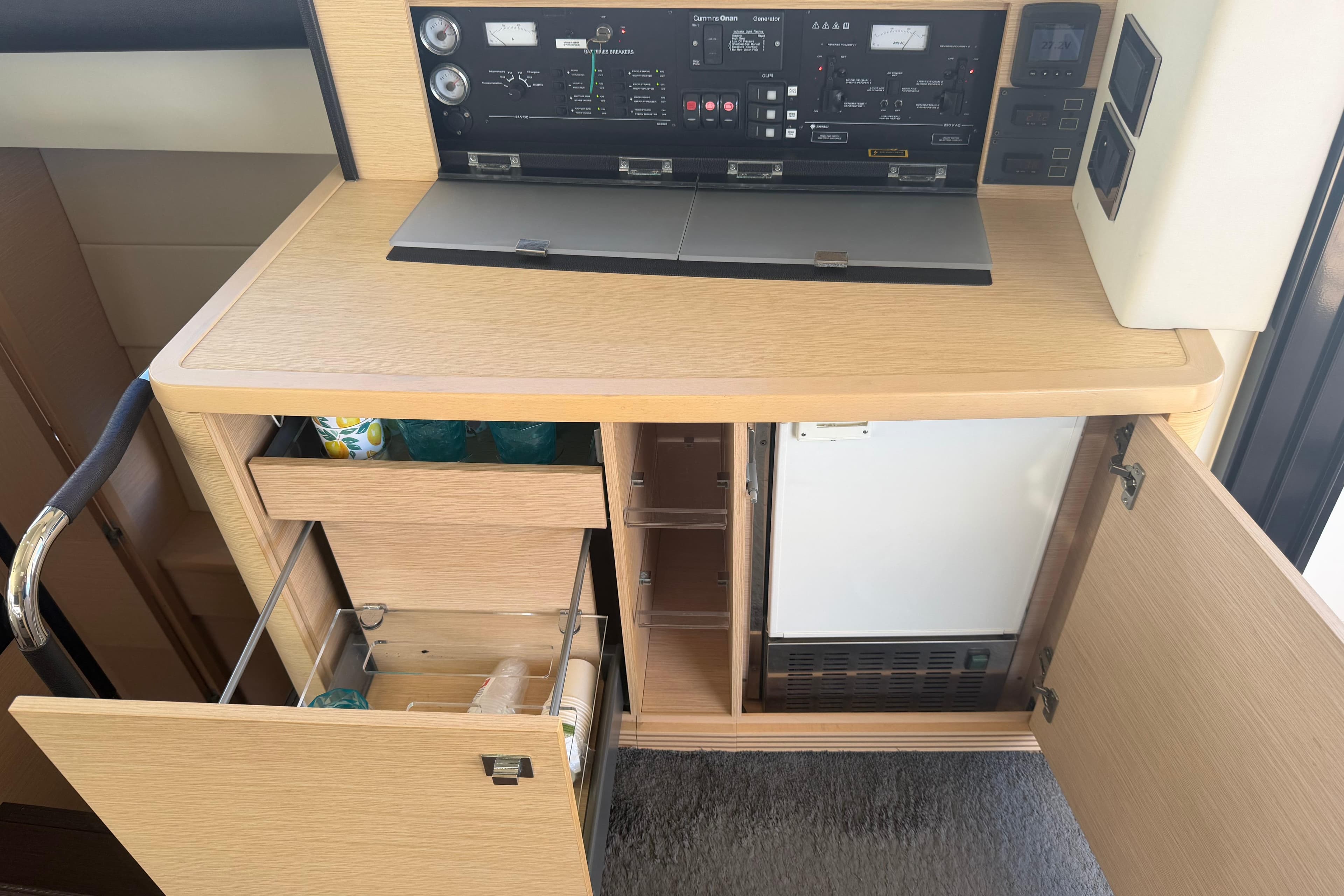 Control panel and storage area inside a 2015 Prestige 550 yacht.