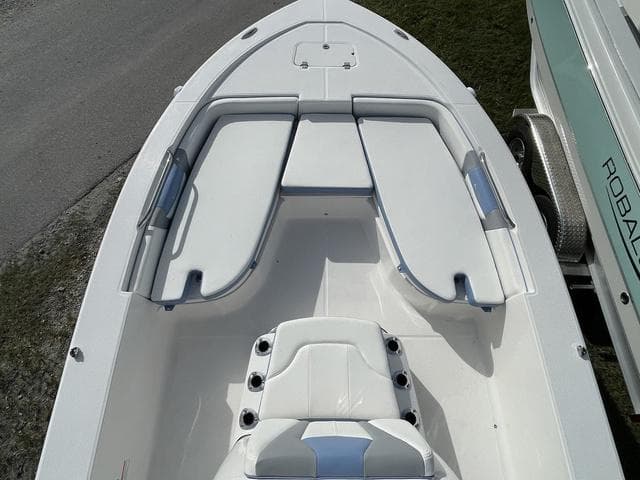 2024 Robalo 206 Cayman boat interior with cushioned seating and storage compartments.