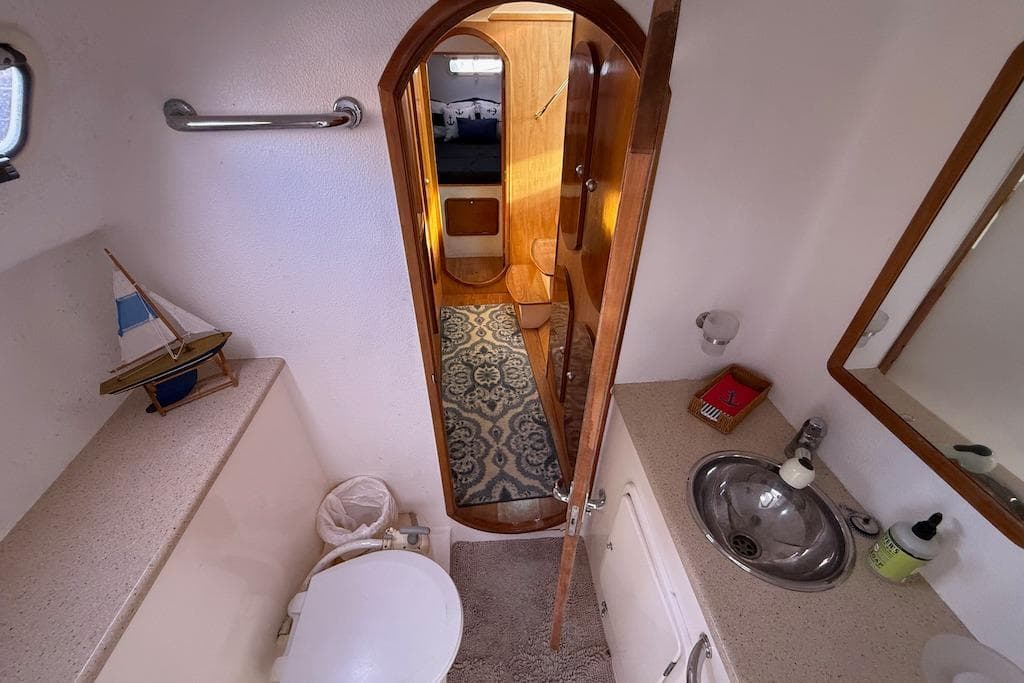Bathroom interior of 2006 Island Spirit 401 yacht with sink, toilet, and nautical decor.