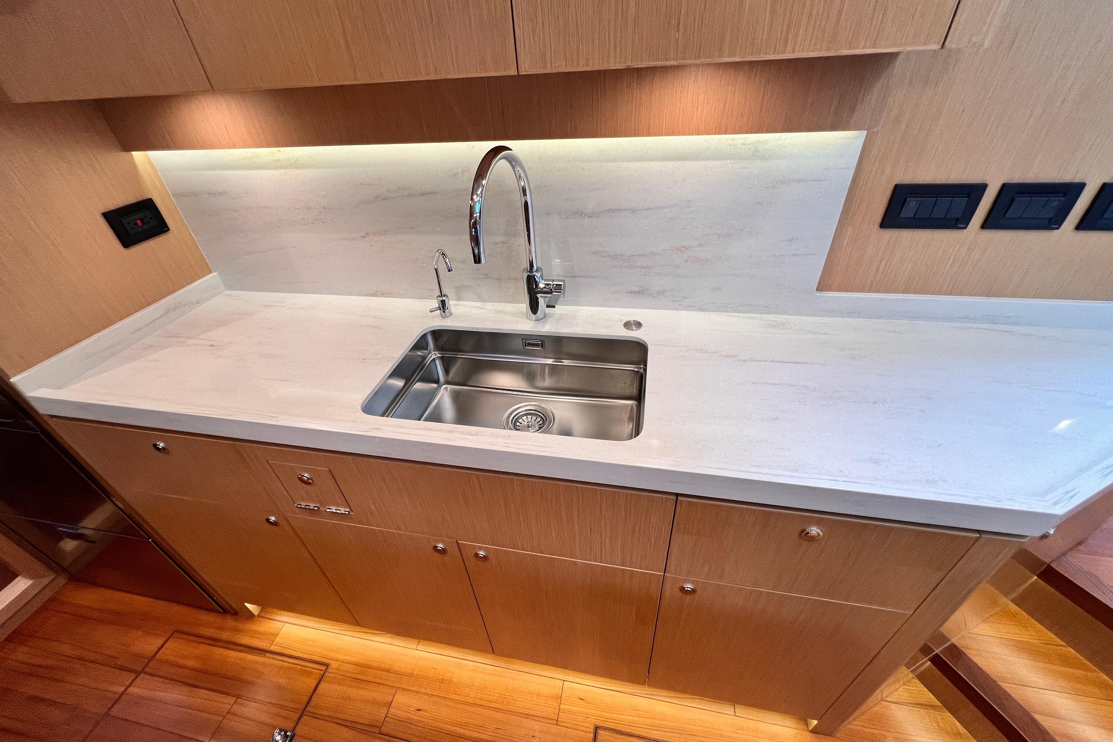 Modern kitchen sink in 2024 Hylas H57 yacht with sleek countertop design.
