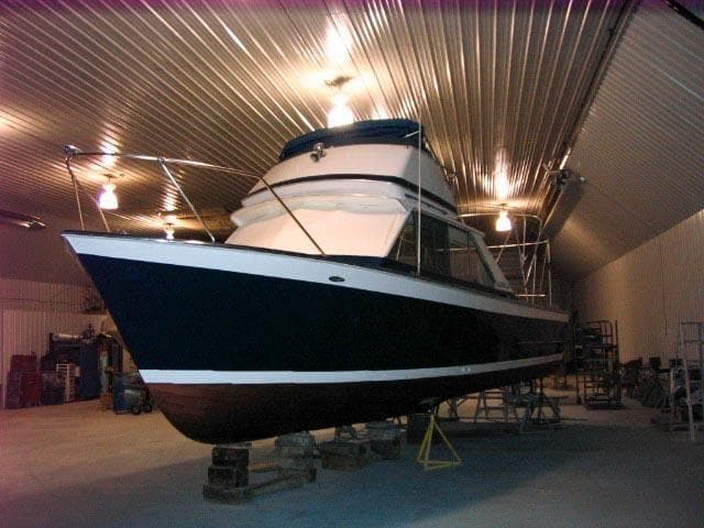 1967 Chris-Craft Sea Skiff 32 Sport Cruiser in a well-lit storage facility.